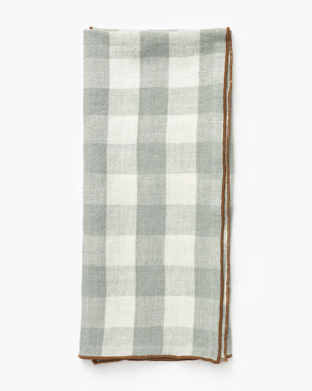The Charlie Check Tea Towel features a folded rectangular design with a light gray and white checkered linen pattern and brown stitched border, ideal for elegant table settings, shown on a white background, by Vendixs