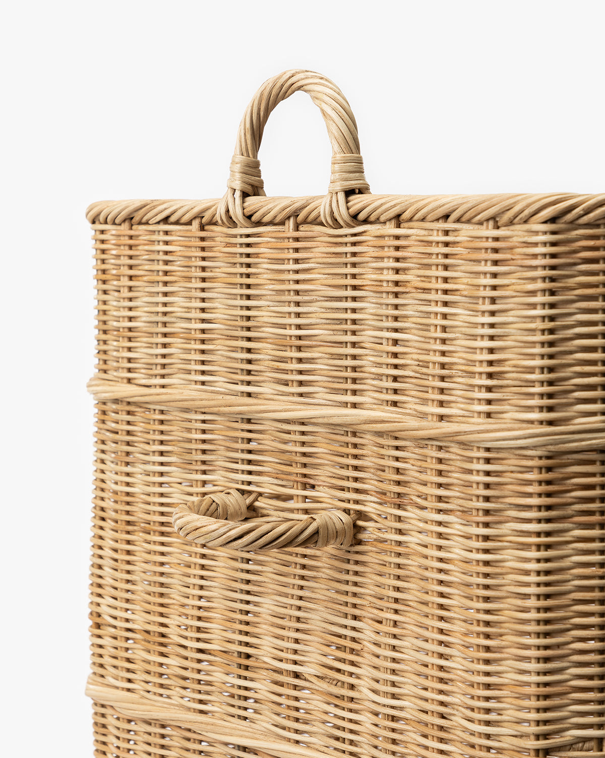 A close-up of the Chiara Laundry Basket, a rectangular wicker hamper with a natural finish, featuring a woven top handle and side handle, perfect for any laundry room, set against a white background, by Vendixs