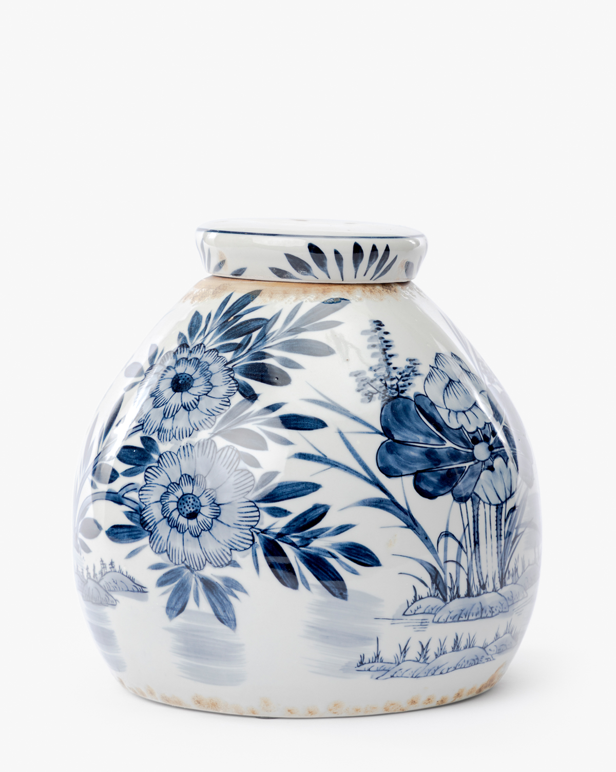 The Chinoiserie Ginger Jar is a round, white ceramic piece with intricate hand-painted blue floral and leaf patterns, detailed with flowers, leaves, and grass. It features a narrow neck and slightly flared rim against a clean white background, by Vendixs