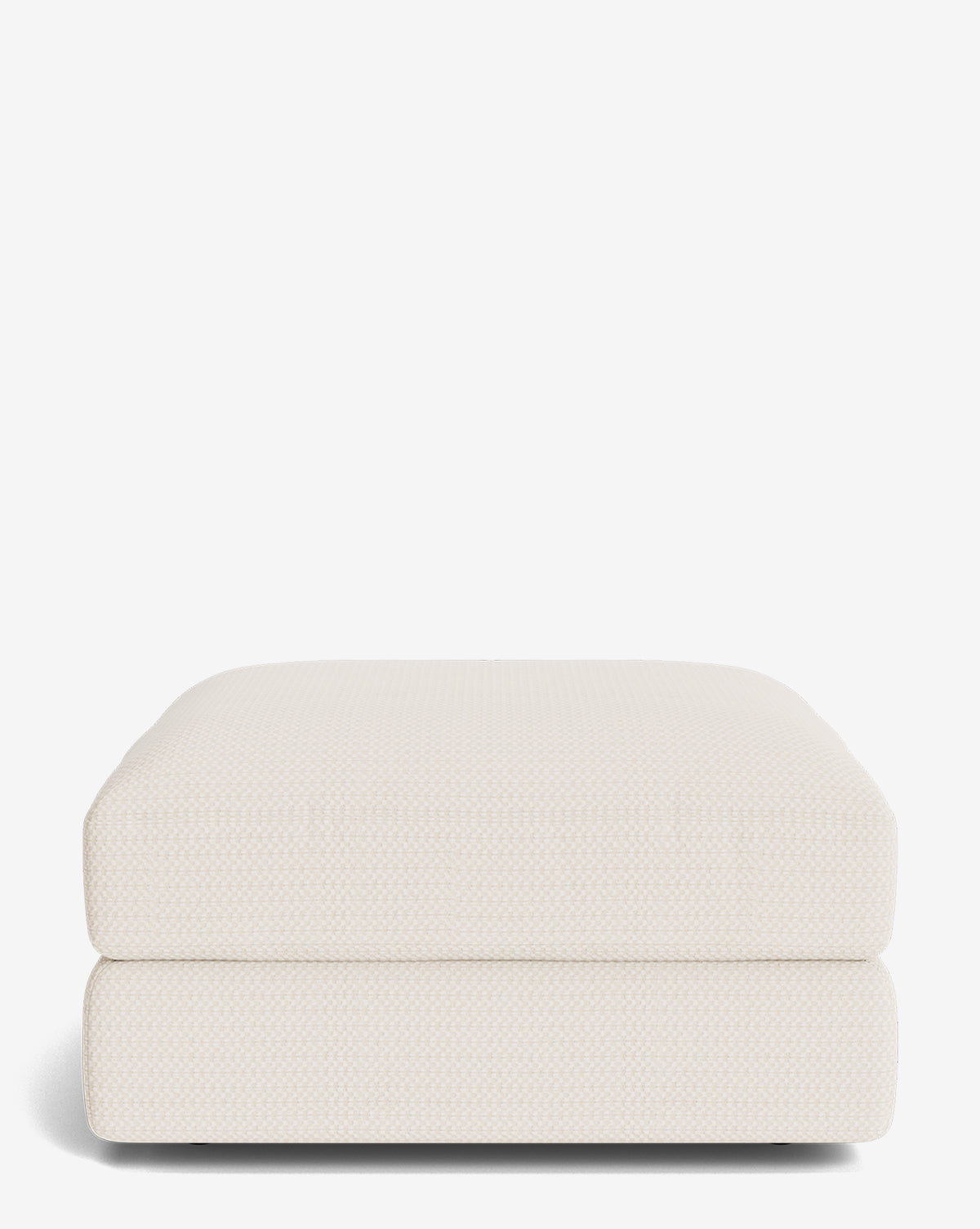 The Makerspalm Claremont Modular Ottoman features a modern rectangular design in light beige with soft, rounded edges and textured fabric, displayed against a plain white background. Vendixs