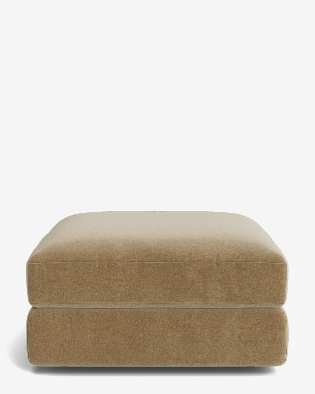 The Makerspalm Claremont Modular Ottoman is a square, light brown piece with a plush cushion top and smooth fabric, displayed against a plain white background. Vendixs