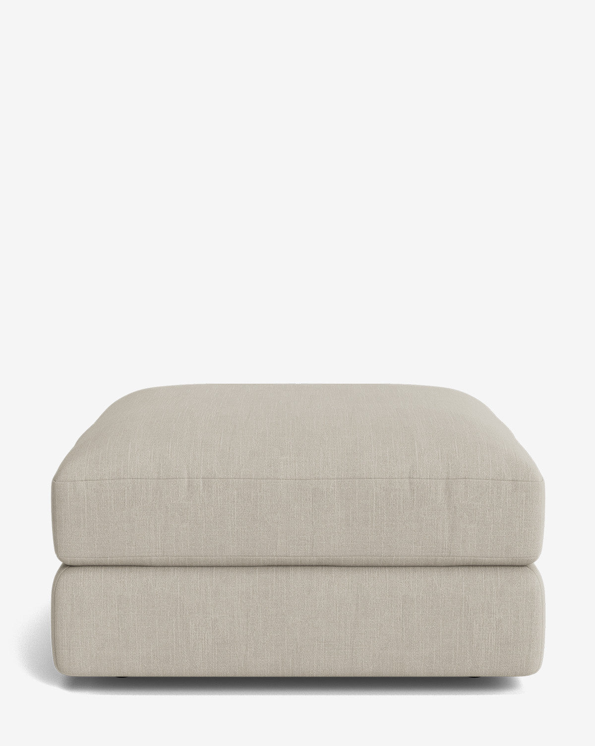 The Claremont Modular Ottoman by Makerspalm is a large, rectangular piece with a simple modern design, upholstered in smooth light beige fabric and shown against a plain white background, Vendixs
