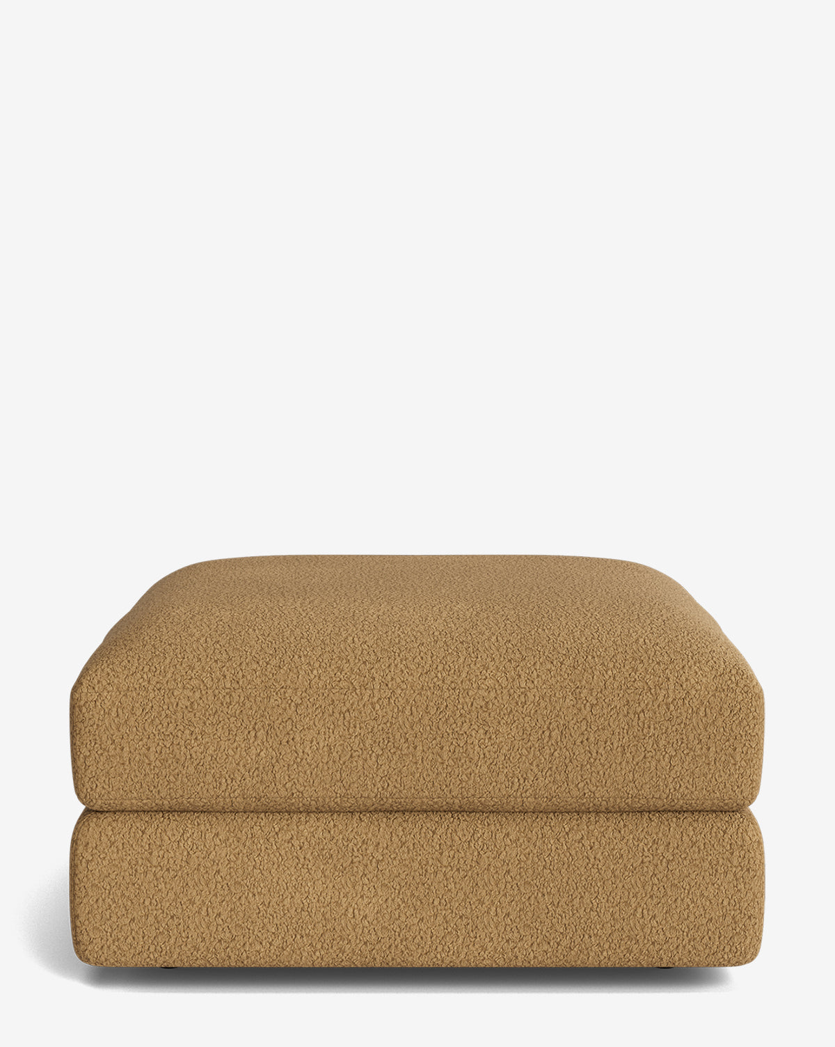 The Makerspalm Claremont Modular Ottoman is shown: a tan, rectangular piece with textured fabric, a low profile, and a simple modern design set against a plain white background. Vendixs