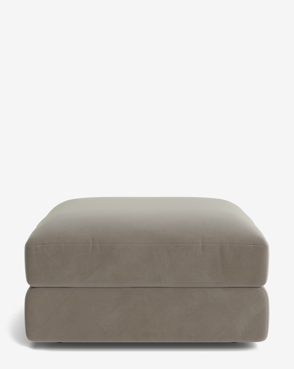 The Makerspalm Claremont Modular Ottoman is a large, rectangular piece in taupe with a smooth, cushioned top and straight sides, shown against a plain white background. Vendixs