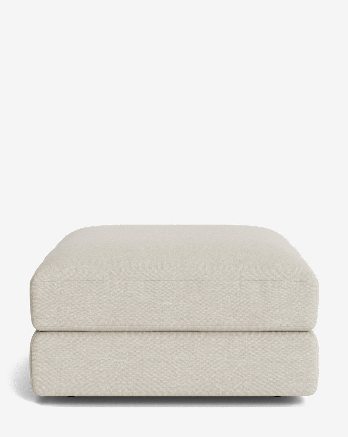 The Makerspalm Claremont Modular Ottoman is a rectangular, light beige upholstered piece with soft, rounded edges and a smooth surface, pictured against a plain white background. Vendixs