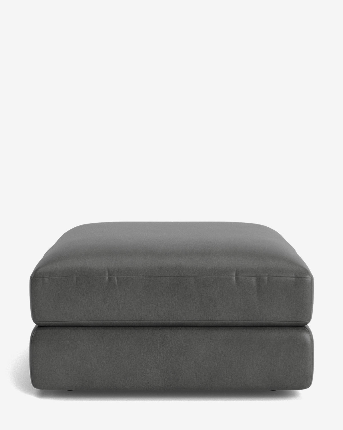 The Makerspalm Claremont Modular Ottoman is a large, rectangular piece in dark gray with a smooth cushioned top and modern, minimalist design, shown against a plain white background. Vendixs