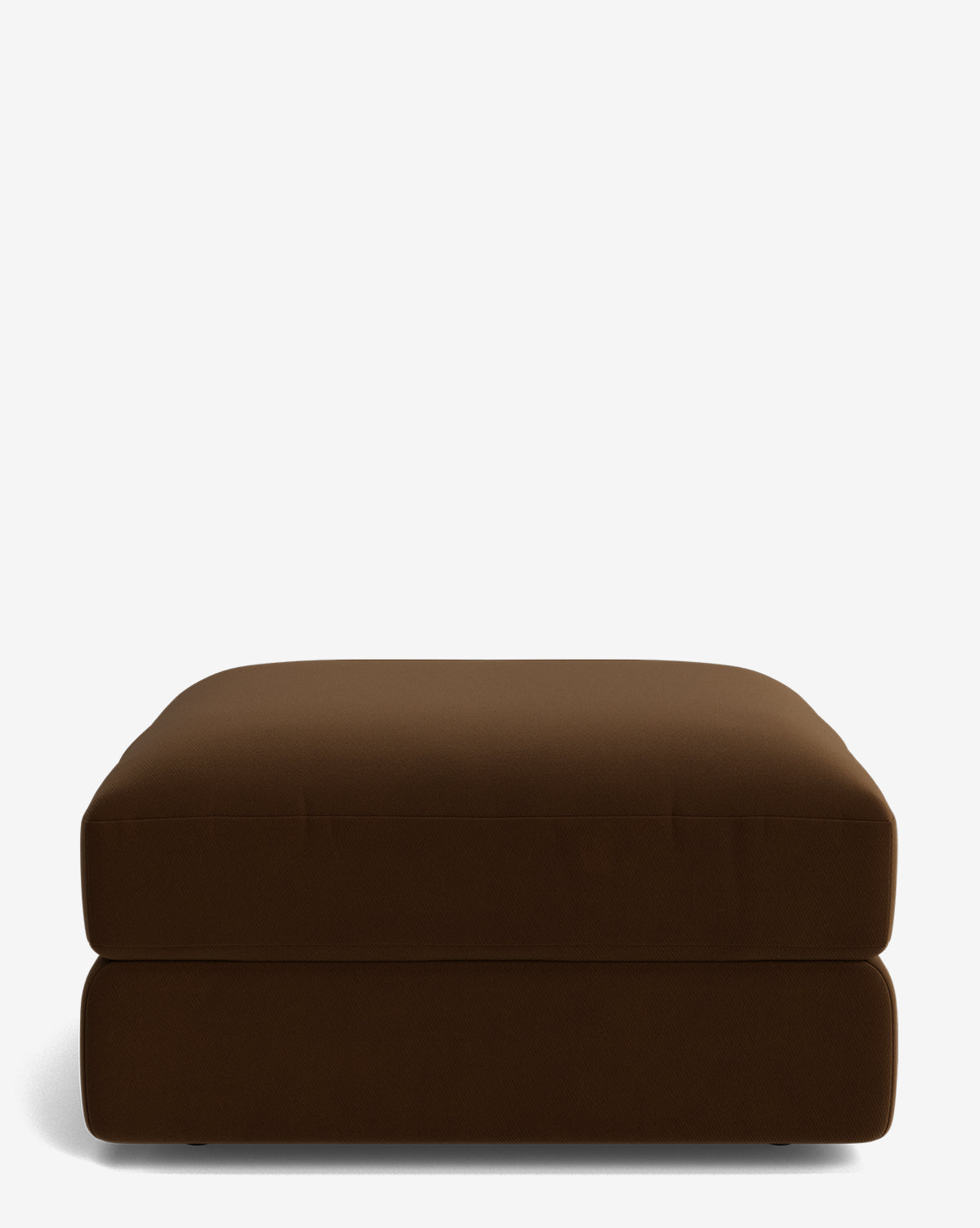 The Makerspalm Claremont Modular Ottoman is a large, rectangular brown piece with a smooth cushion and minimalist design, shown on a plain white background. Vendixs