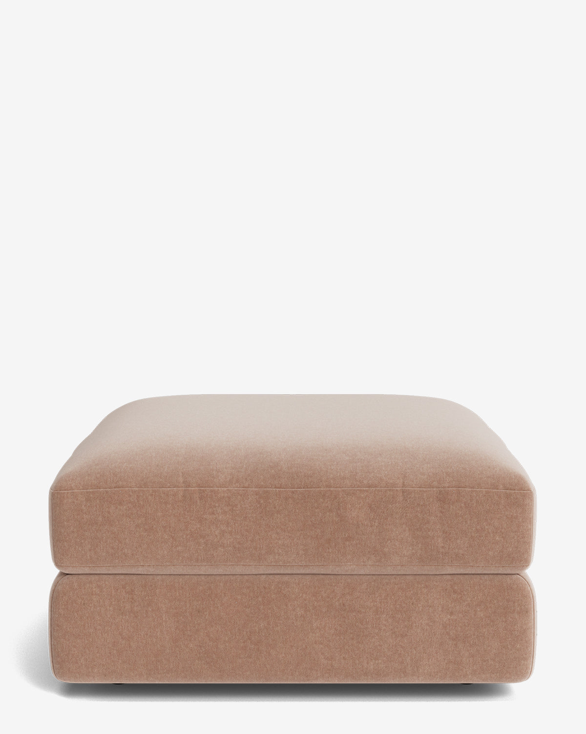 The Makerspalm Claremont Modular Ottoman is a rectangular, light brown upholstered piece with soft, rounded edges and a vintage-inspired design, shown against a plain white background. Vendixs