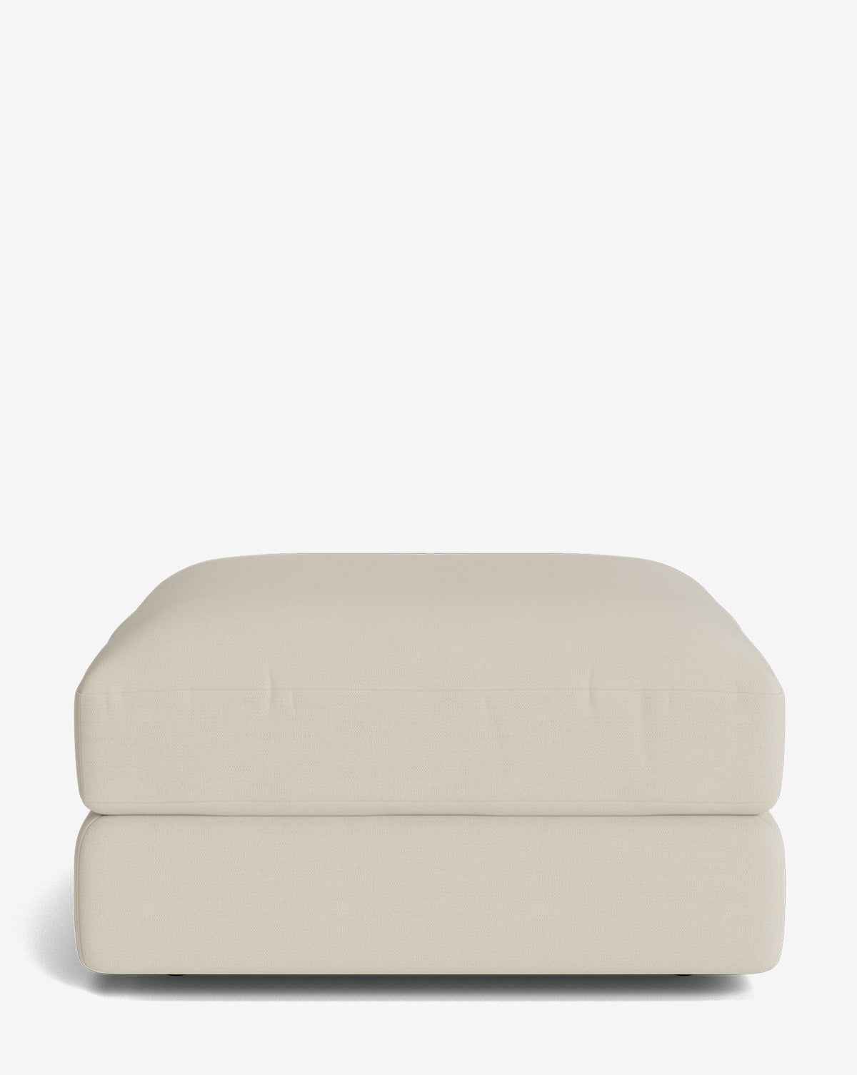 The Makerspalm Claremont Modular Ottoman features a beige, rectangular design with a plush cushioned top and modern simplicity, shown on a white background. Part of the Claremont modular collection. Vendixs