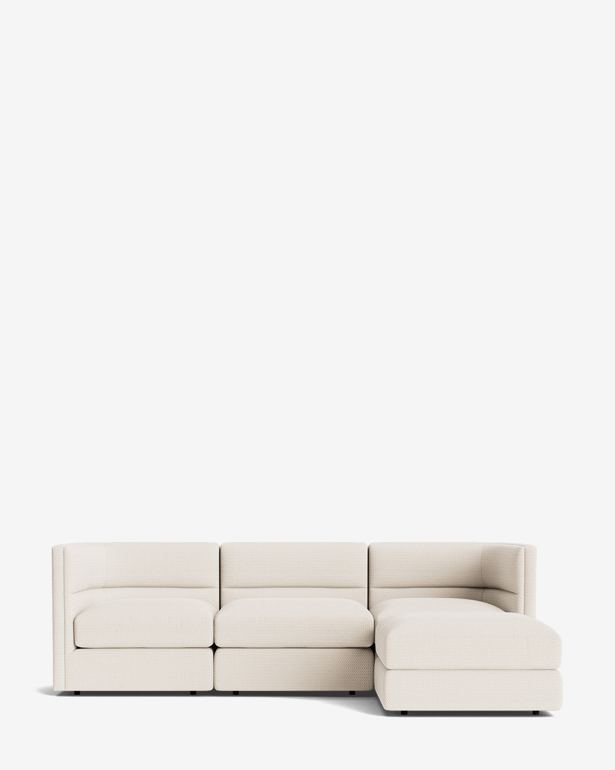 The Makerspalm Claremont Modular Sofa with Ottoman 99 is a modern, light beige three-seater featuring a right-side chaise lounge, shown against a plain white background. Vendixs