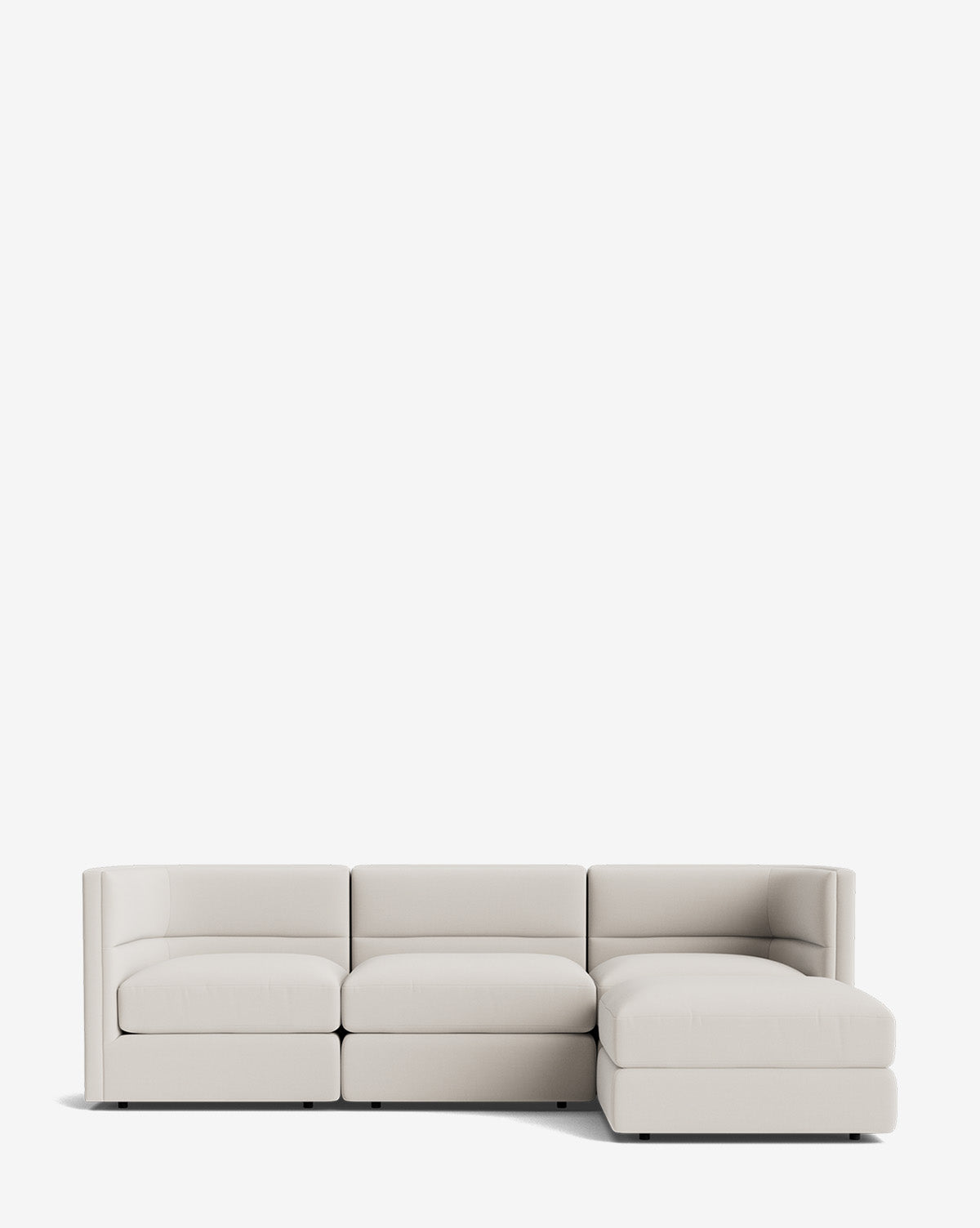 The Makerspalm Claremont Modular Sofa with Ottoman 99 features a modern, light beige design with three seat cushions and a right-side chaise, showcasing clean lines and minimalistic style against a plain white background by Vendixs