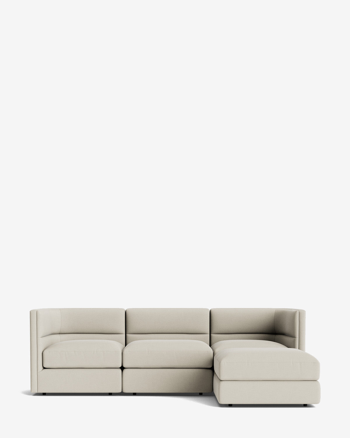 The Claremont Modular Sofa with Ottoman 99 features a modern light beige design, three seat cushions, a right-side chaise lounge, and a sleek channeled back, all set against a plain white background by Vendixs