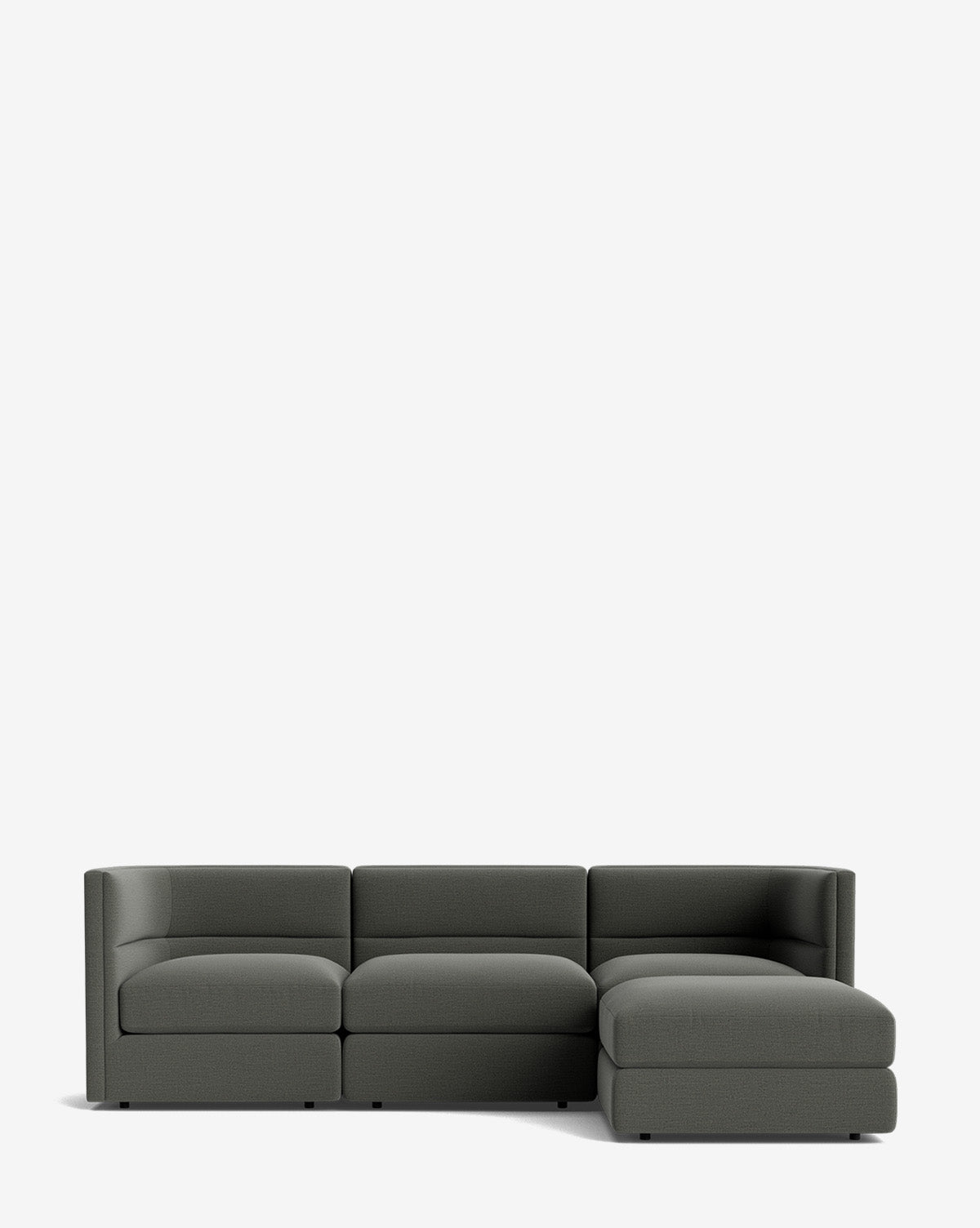 The Makerspalm Claremont Modular Sofa with Ottoman 99 is a modern, dark gray three-seater with a right-side chaise lounge, shown against a plain white background. Vendixs