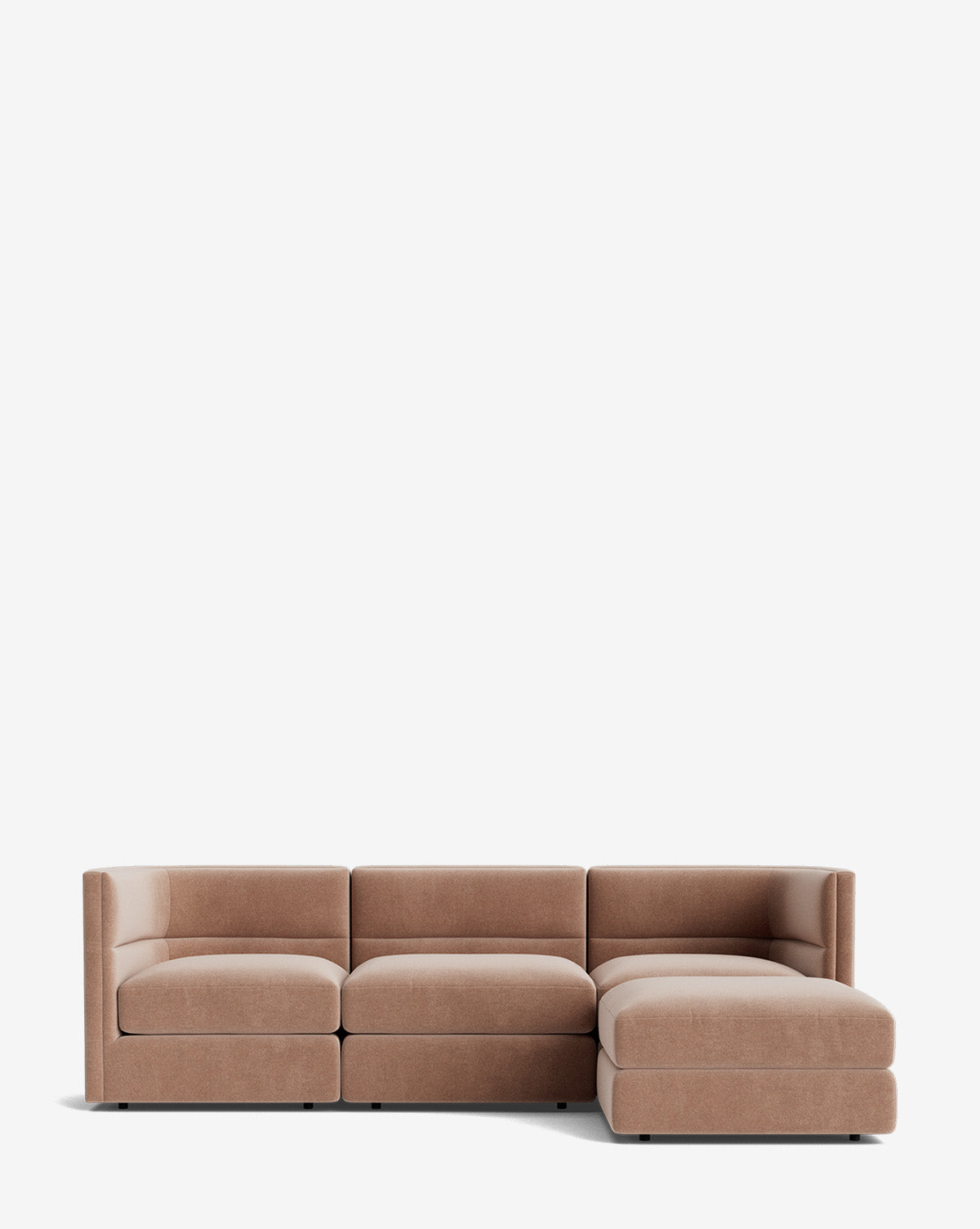 The Claremont Modular Sofa with Ottoman 99 is a modern sectional with low backs, armrests, light brown upholstery, channeled back, three seats, and a right-side chaise lounge, shown against a plain white background by McGee & Co.