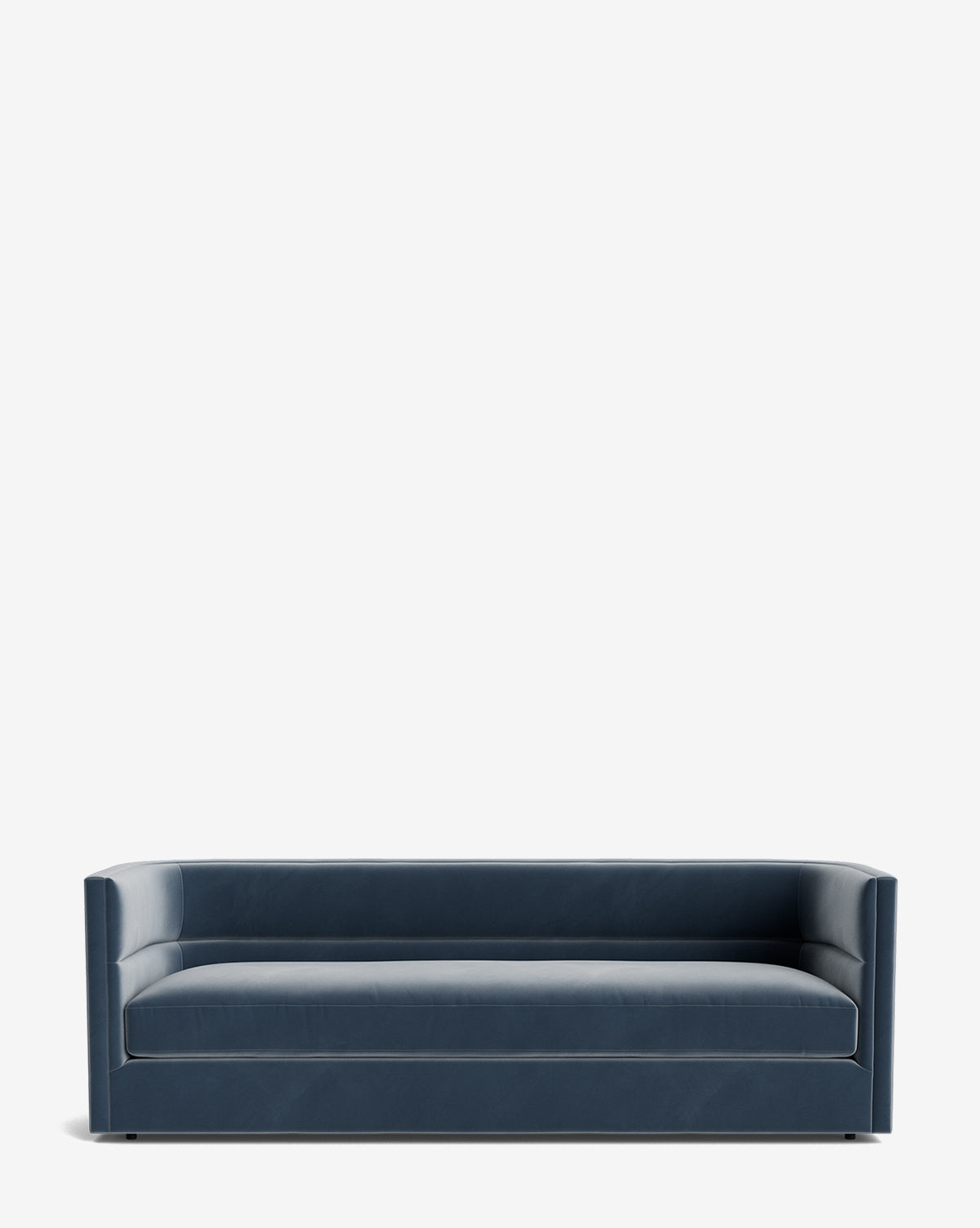 The Claremont Sofa 84 is a modern, dark blue piece featuring clean lines, a low back, and armrests of equal height, crafted from high-quality fabric and showcased against a plain white background by McGee & Co.