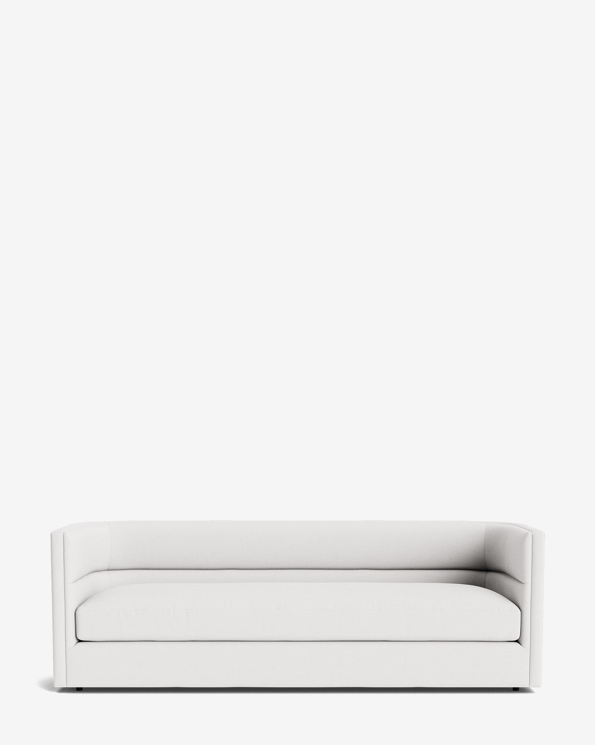 The Claremont Sofa 84 features a modern, minimalist design with a low backrest, straight armrests, and high-quality fabric upholstery, displayed against a plain white background by McGee & Co.