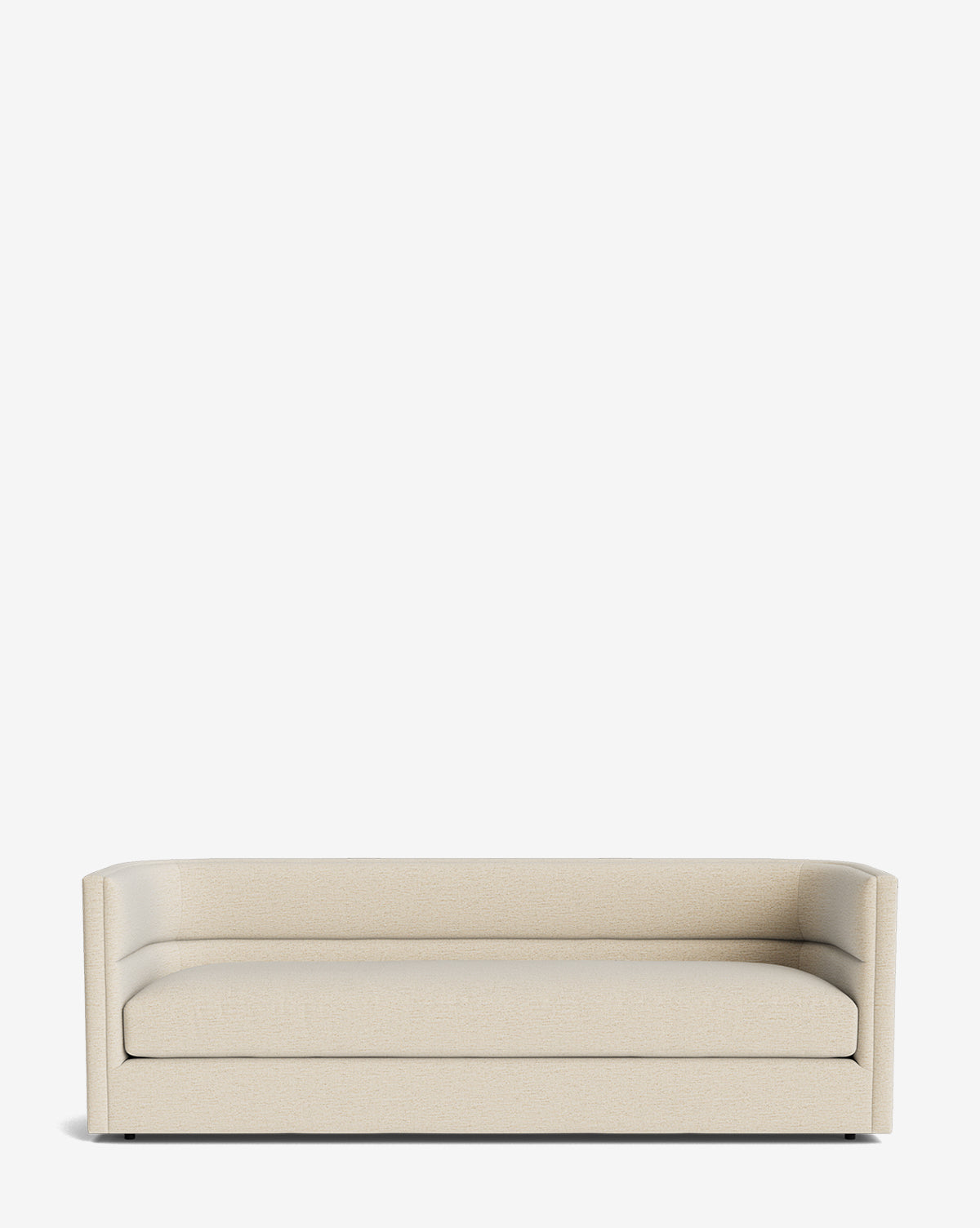 The Claremont Sofa 84 is a modern, minimalist piece in high-quality fabric with low armrests, a straight back, and clean lines. Its sleek design lacks visible decorative details and is photographed against a plain white background by McGee & Co.