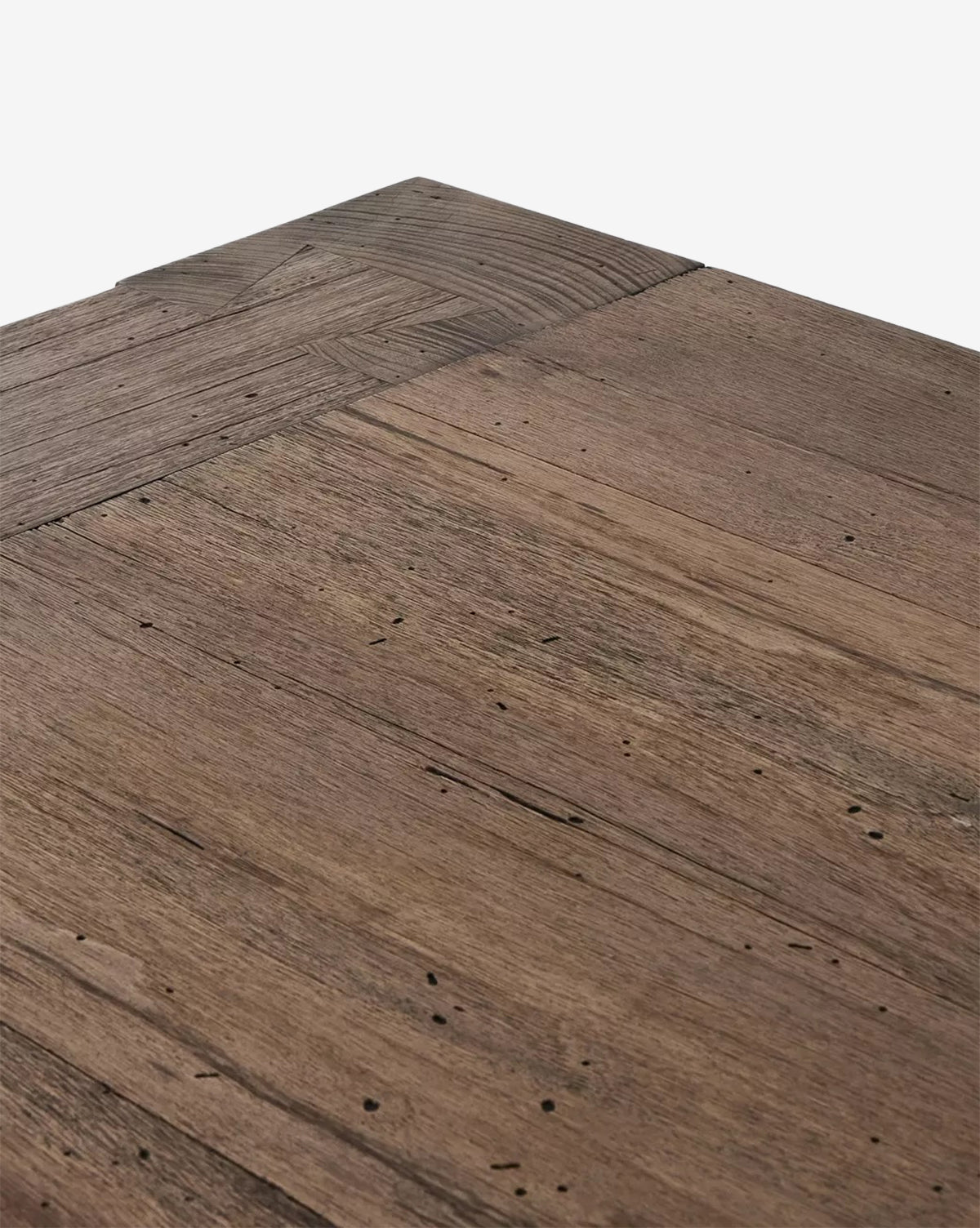 Close-up of the Clellan Dining Tables corner, showcasing its modern design with a natural, rustic finish that highlights the oak veneer’s grain patterns, subtle color variations, and small imperfections, by Vendixs