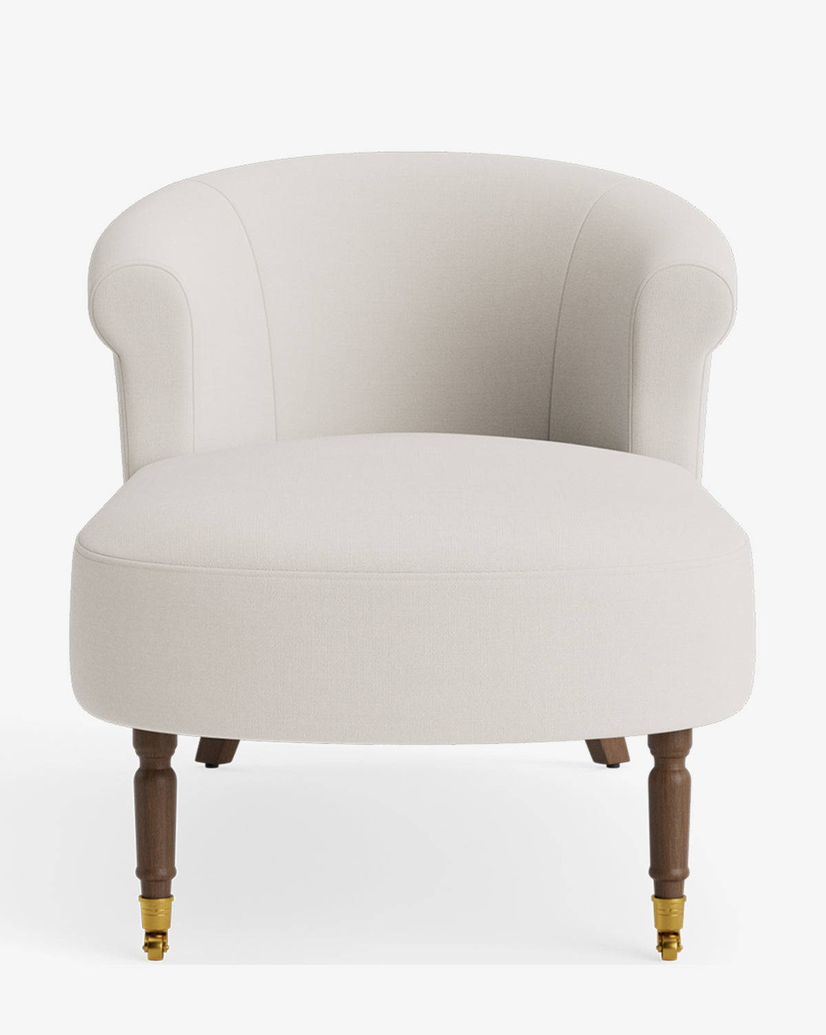 The Clemence Chaise is a cream upholstered armchair with a curved back, rounded arms, and wooden legs—two with brass castor wheels at the front—shown against a white background by McGee & Co.