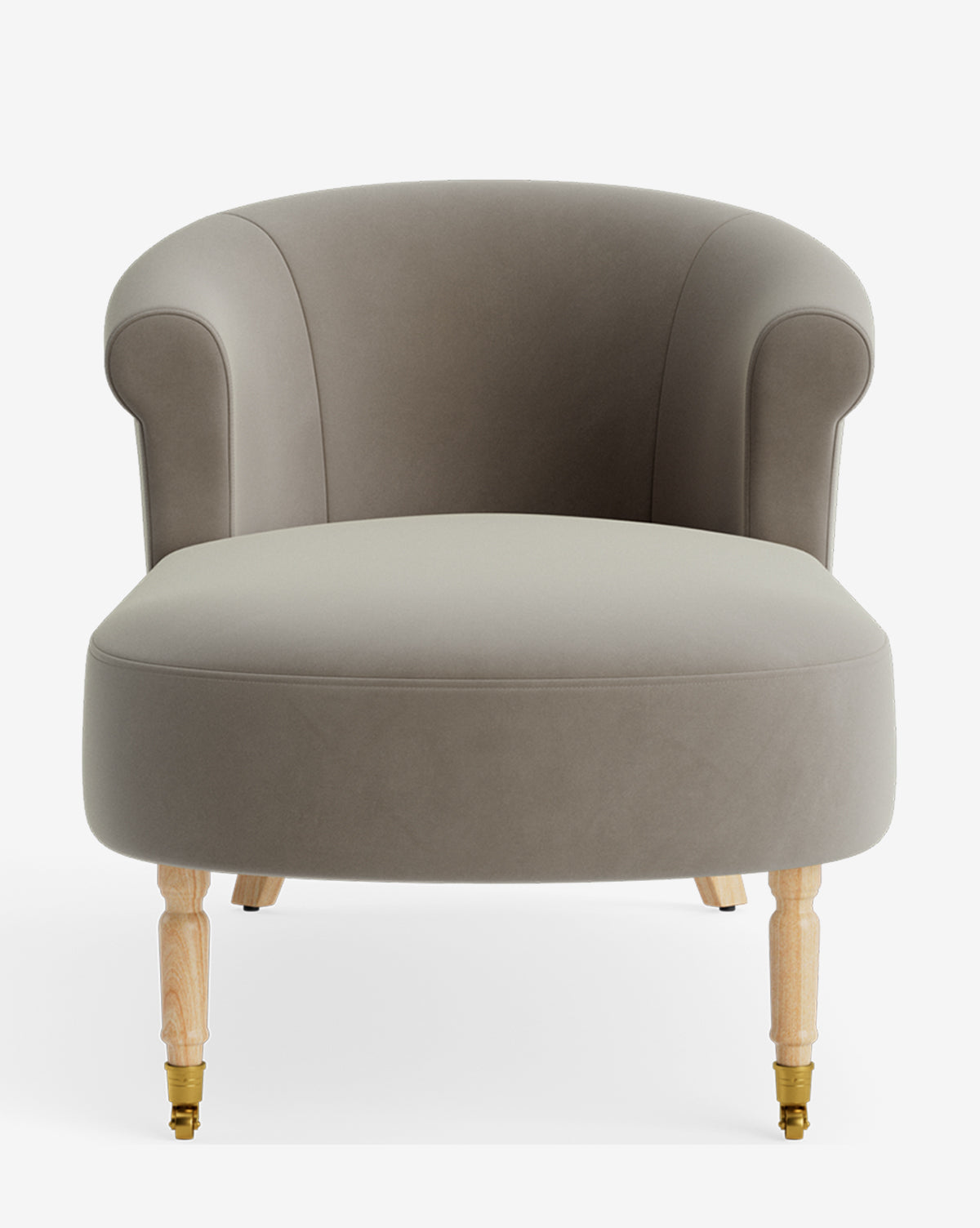 The Clemence Chaise is a modern accent chair with a rounded back, soft taupe upholstery, and light wooden legs with front brass casters, displayed against a white background. Ideal for customizable furniture collections by Vendixs