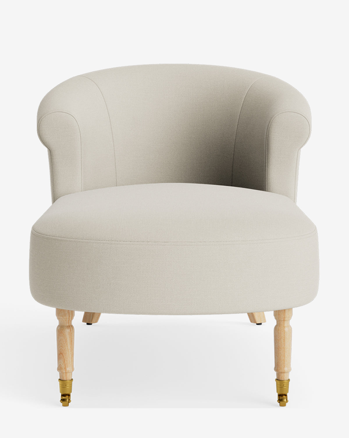 The Clemence Chaise, a beige upholstered accent chair with a curved backrest, rounded armrests, and light wooden legs with brass casters, brings customizable elegance to any space and is shown against a plain white background by McGee & Co.