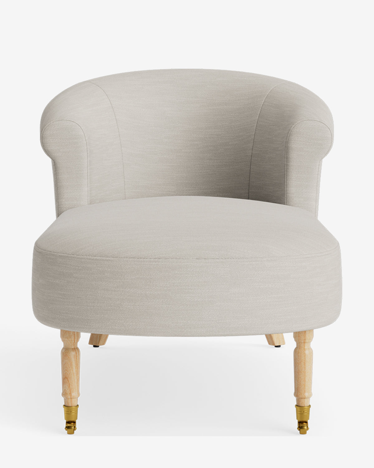 The Clemence Chaise is a modern light beige accent chair with a rounded back, armrests, and four light wood legs—front two featuring brass casters. Inspired by the classic chaise lounge, its perfect for fans of customizable furniture by McGee & Co.