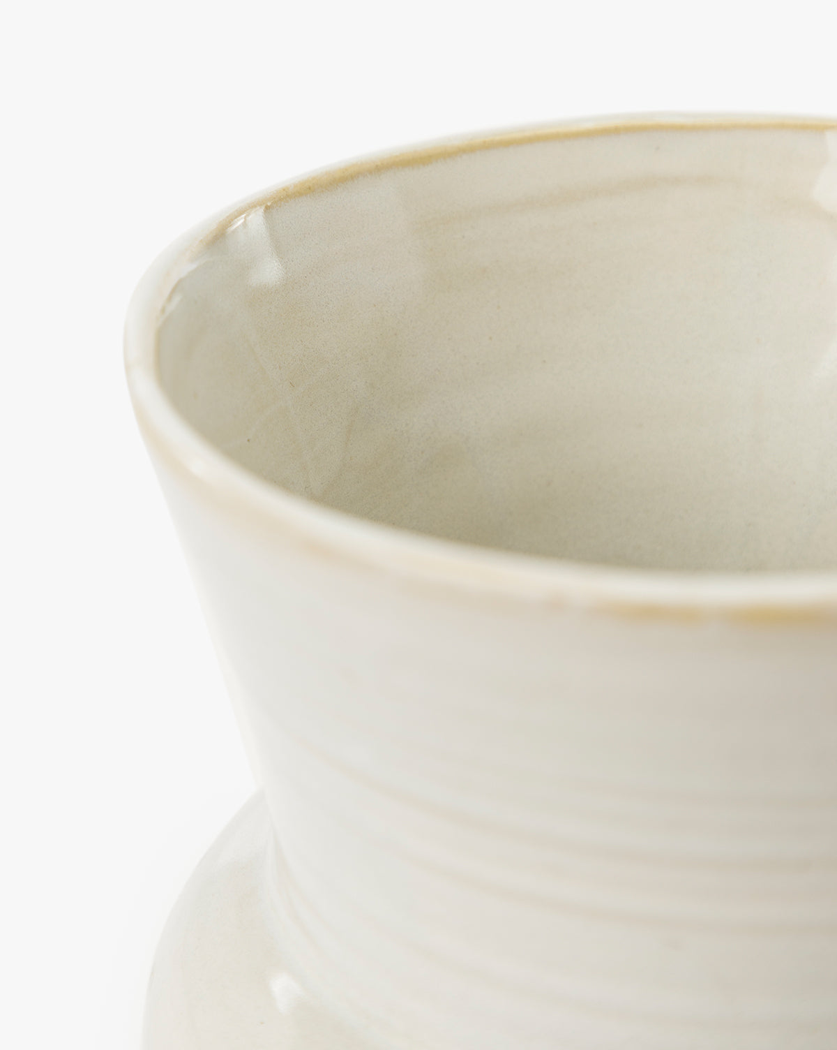 A close-up of the upper portion of the cream-colored Colchester Planter, crafted from high-quality ceramic with a glossy finish and subtle horizontal lines—ideal for enhancing your home decor, by Vendixs