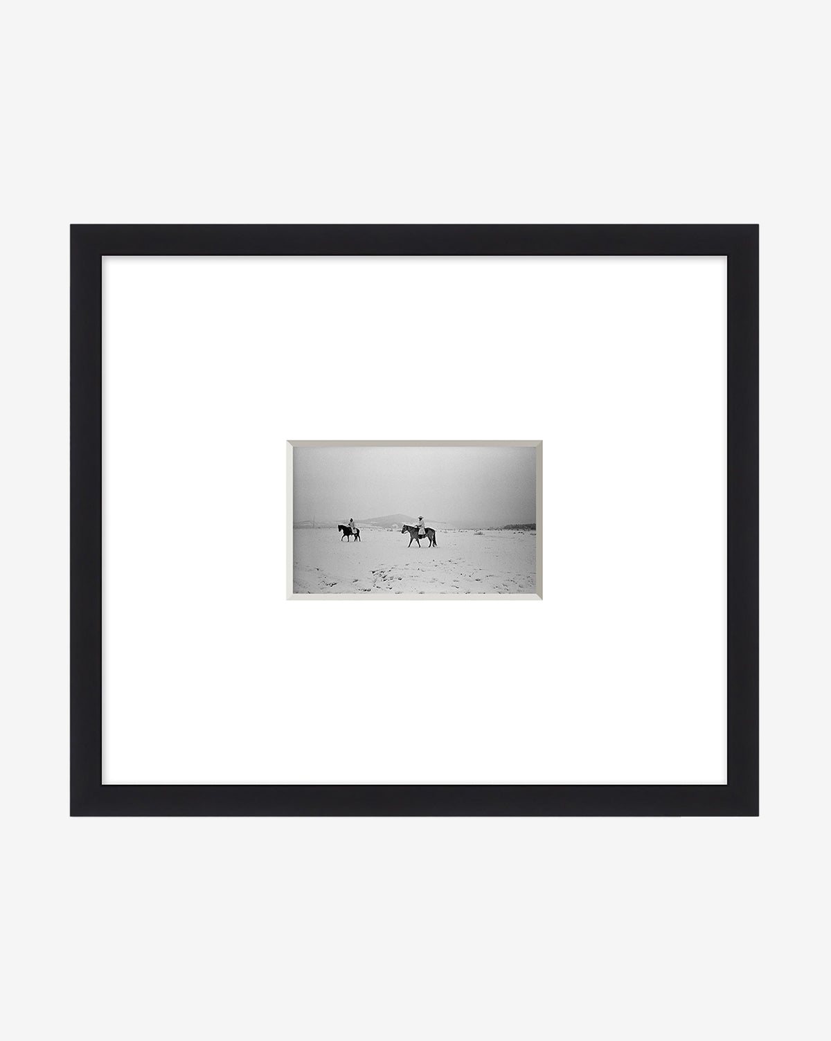 The Cold Voyage giclee print features two horseback riders crossing a flat landscape, centered within wide white matting and set in a sleek black frame, evoking the spirit of adventure, by Vendixs