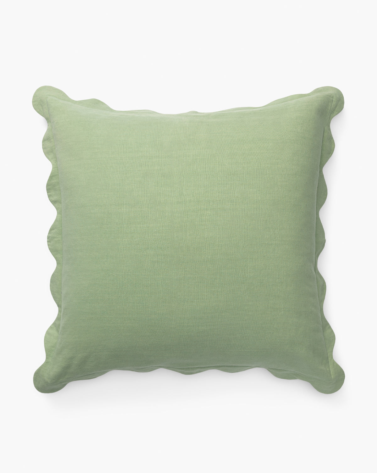 The Vendixs x Loeffler Randall Colette Scallop Border Pillow Cover is square, light green linen with gently scalloped edges, shown against a plain white background by Vendixs