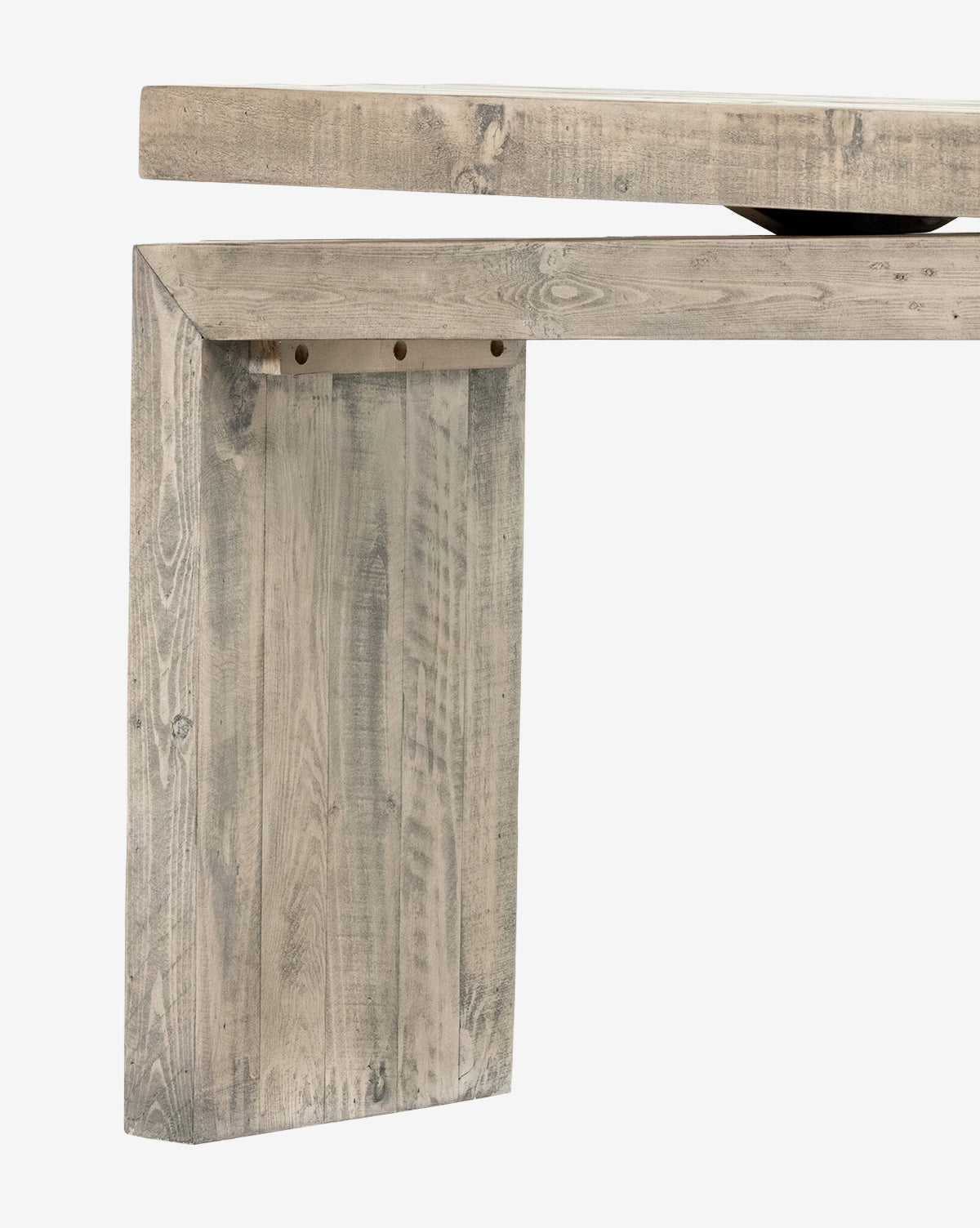 Close-up of the Colter Console Table, a modern entryway piece made from reclaimed wood with a rustic light gray finish, showcasing its thick rectangular leg and tabletop edge against a white background, by Vendixs