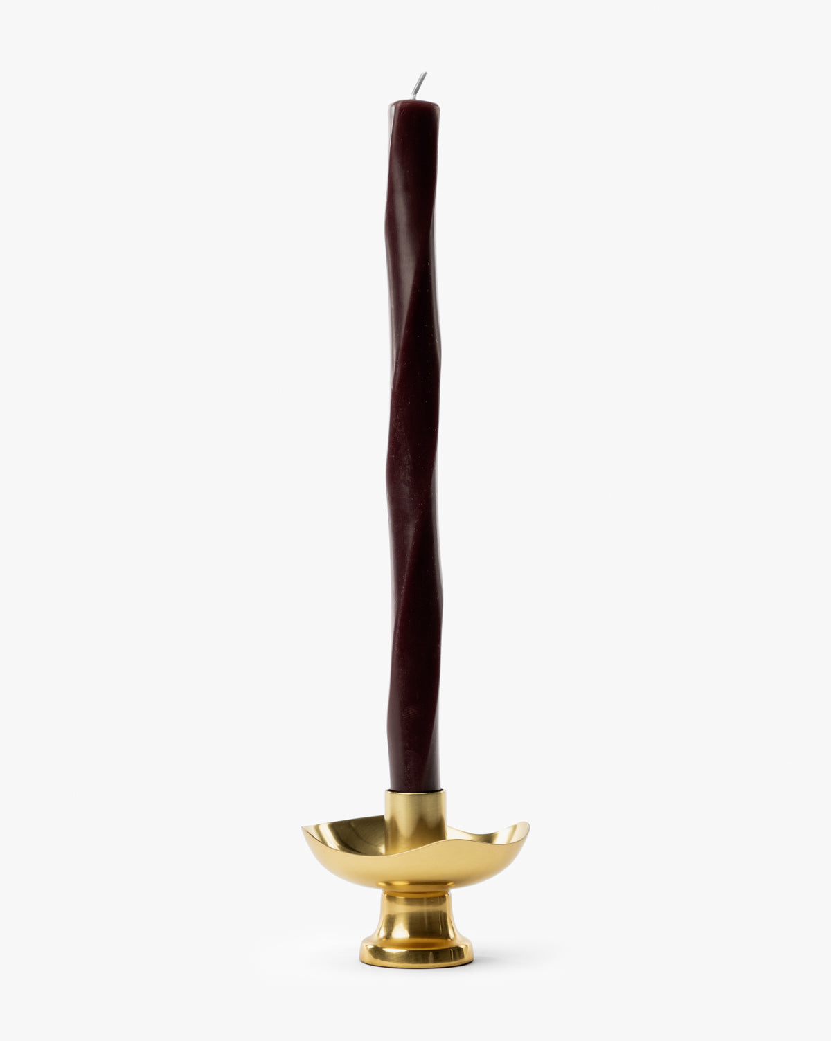 A tall, dark burgundy twisted candle stands upright in the Cosima Taper Holder, an antique brass candle holder set against a plain white background—ideal for elegant decor, by Vendixs