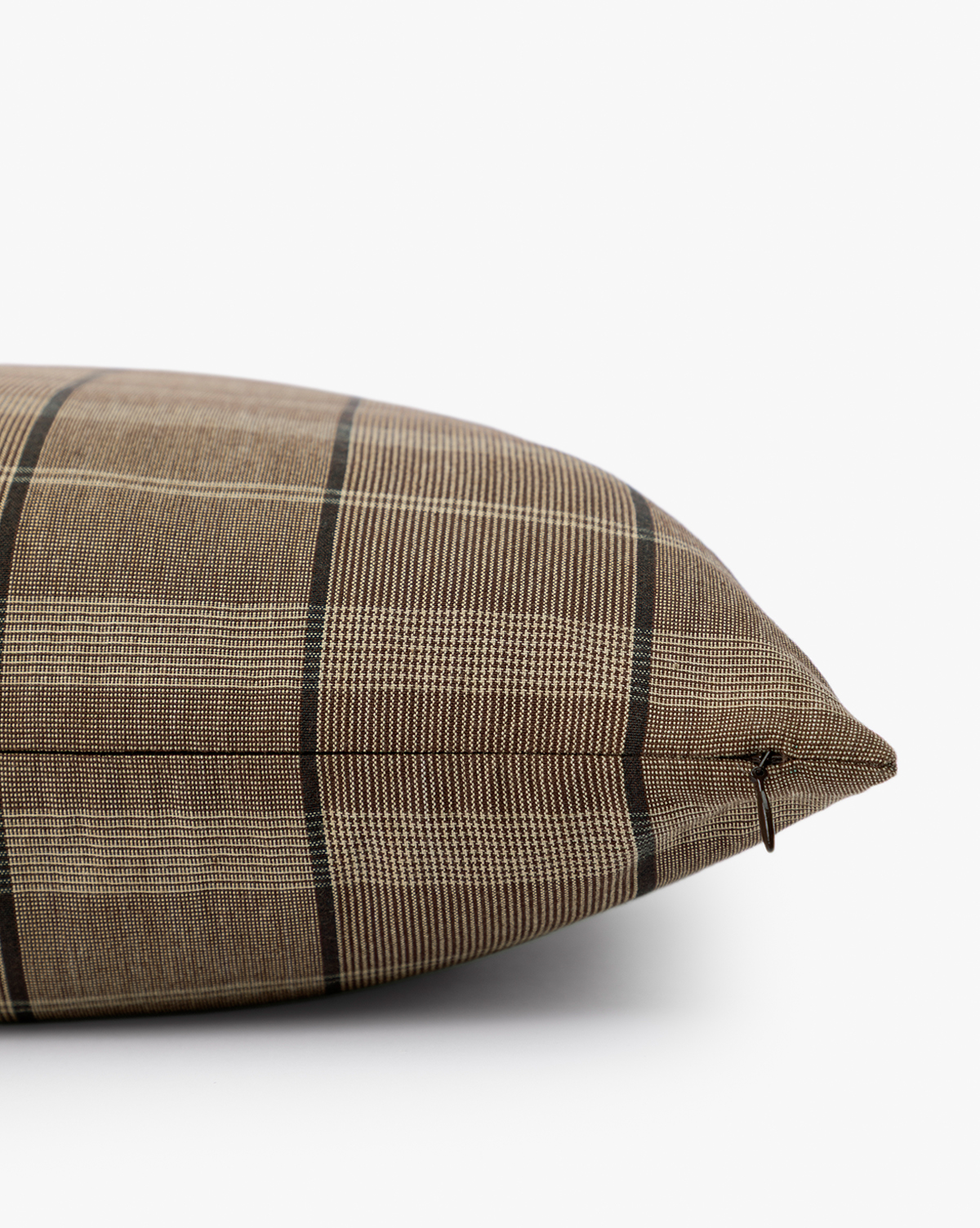 A close-up side view of the Curtis Pillow Cover in brown plaid with a subtle checkered pattern, displayed on a white surface against a plain background—a stylish decorative accent for any space, by Vendixs