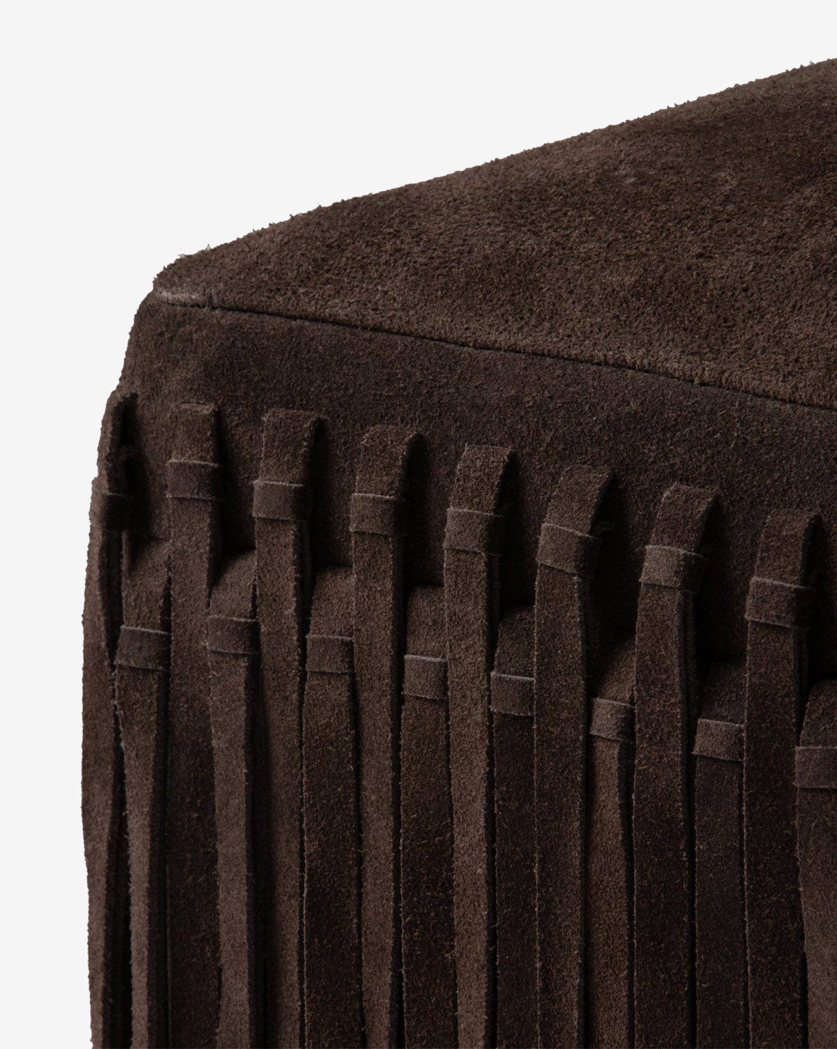 Close-up of the Made Goods Damian Ottoman in a rich camel color, showcasing vertical fringe accents on the sides and a smooth, suede-textured top. Vendixs