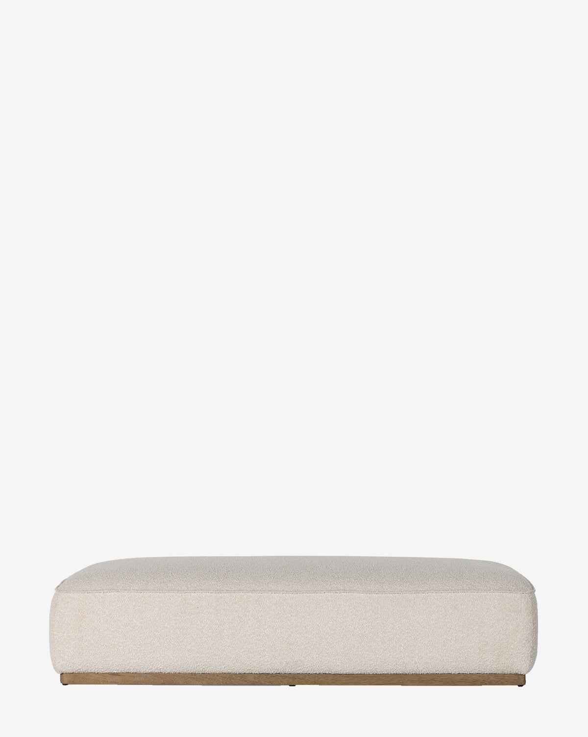 The Dawson Rectangular Ottoman by Four Hands features a low profile, flat top, rounded edges, and beige upholstery on a parawood base, shown against a plain white background. Vendixs