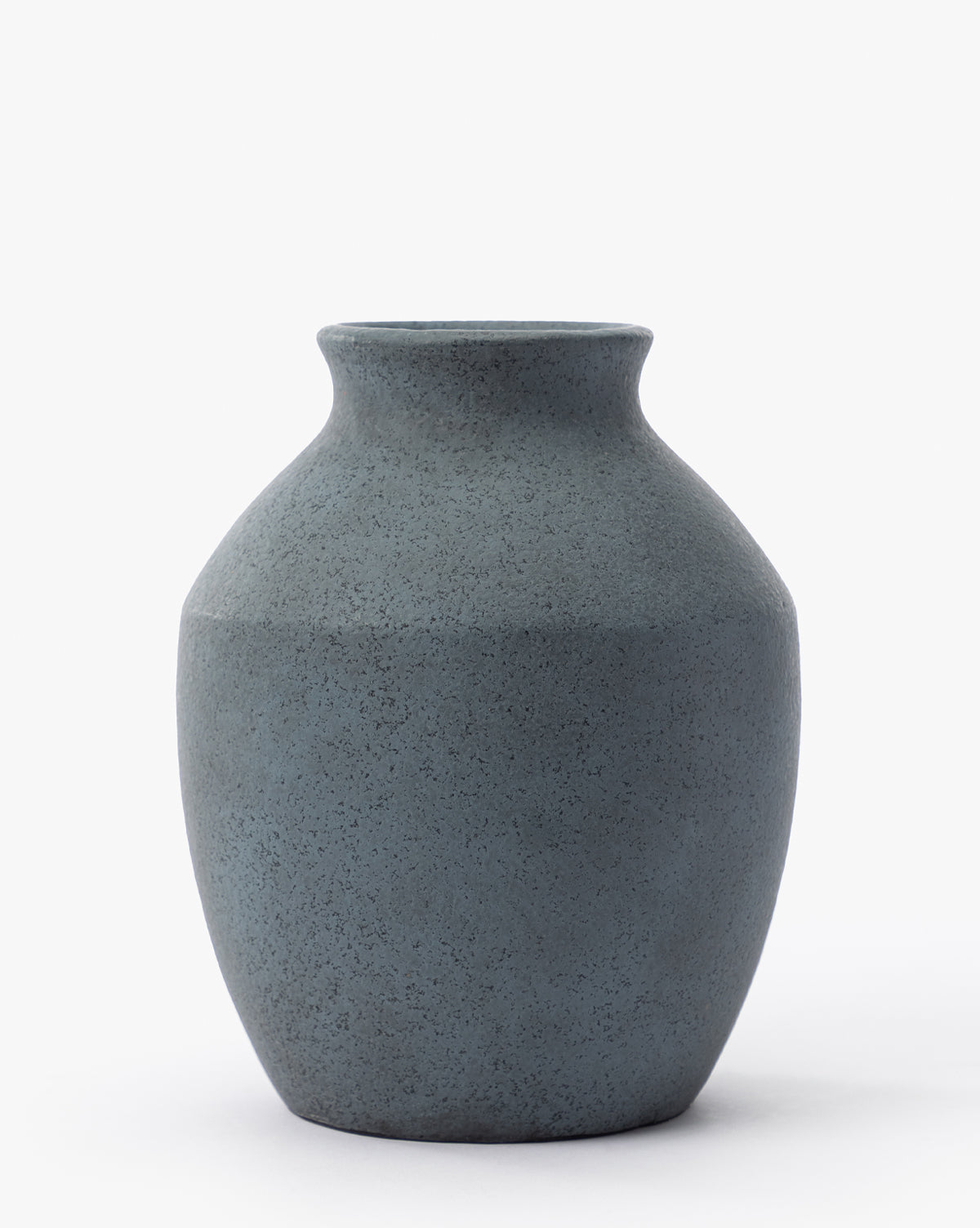 The Delgado Vase is a matte dark gray piece featuring a wide rounded body, narrow neck, and slightly flared rim, displayed on a plain white background, by Vendixs
