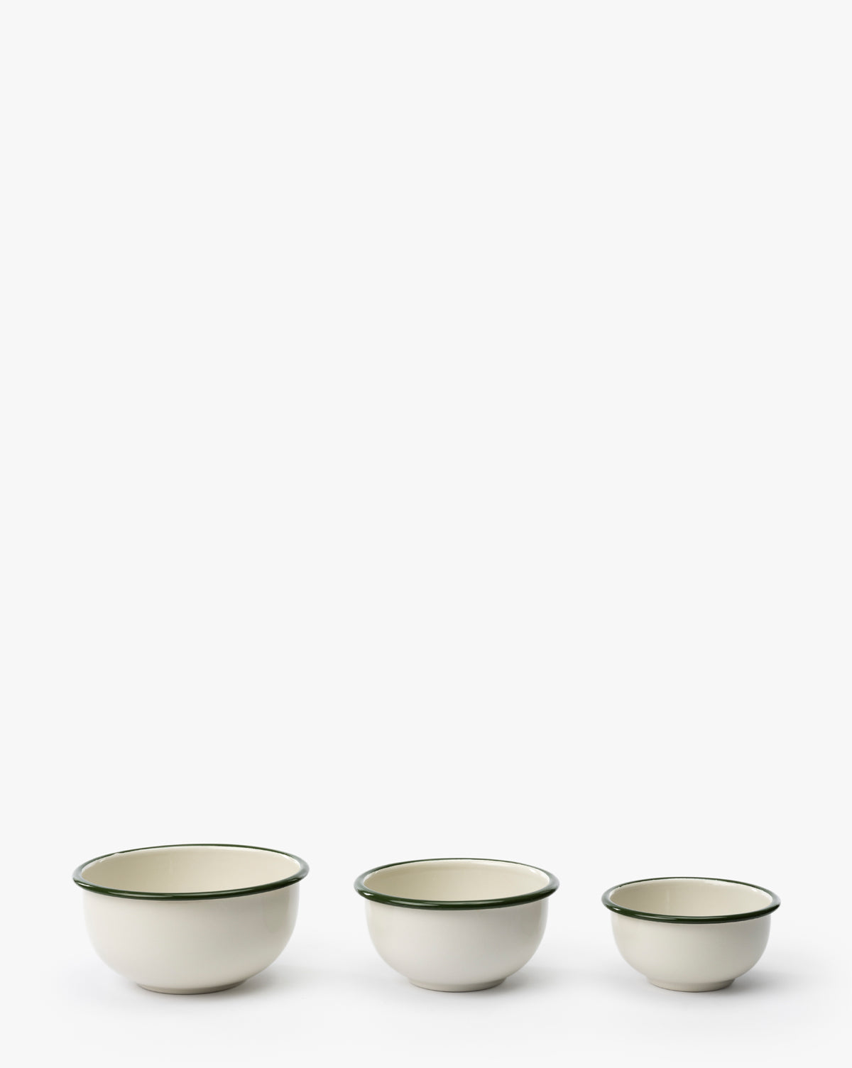The Delia Bowls (Set of 3) feature vintage-inspired green rims and durable white enamel. Arranged from largest to smallest, they bring timeless charm to your kitchen—perfect for daily use or as a display piece by Vendixs