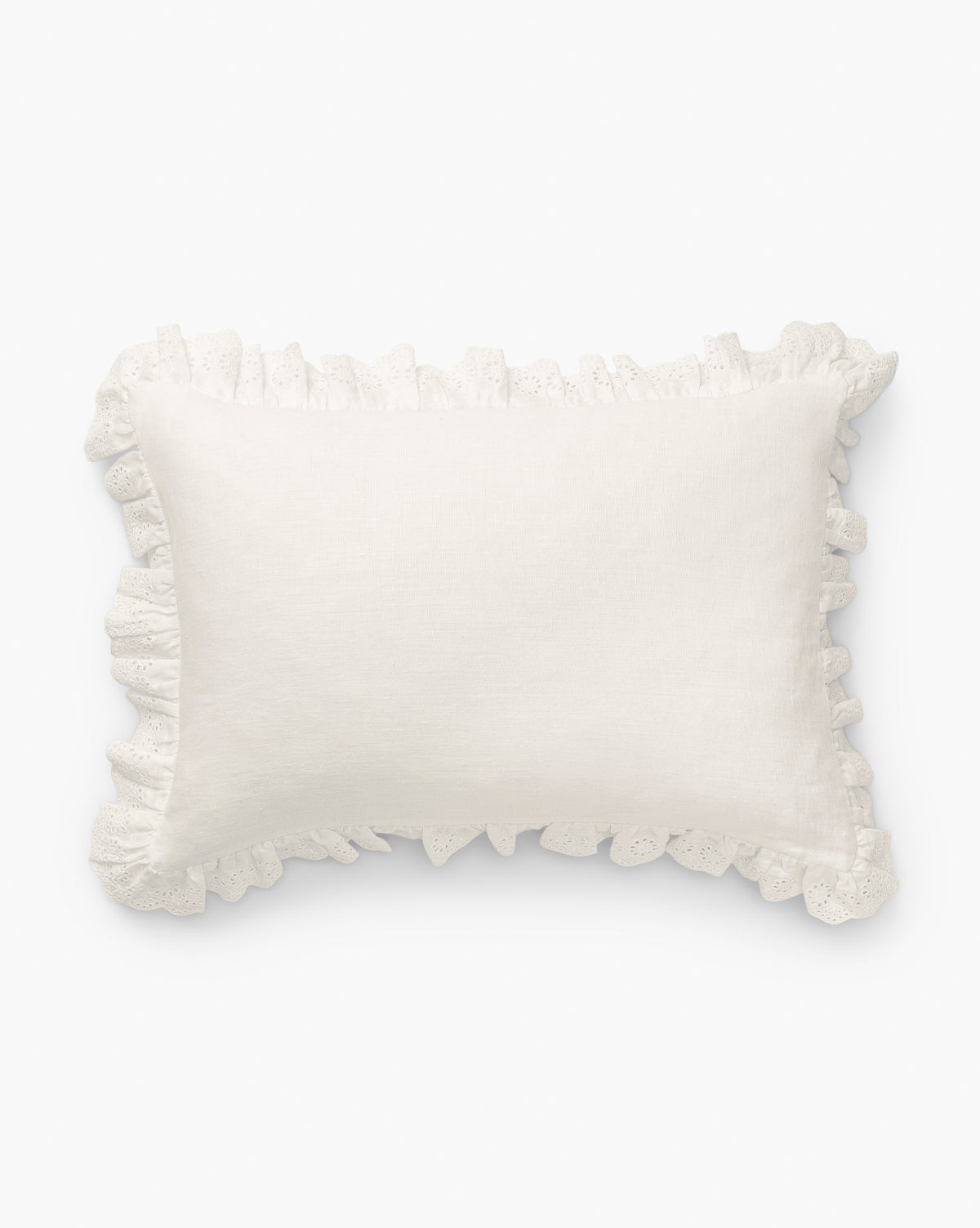 The Vendixs x Loeffler Randall Delilah Broderie Trim Pillow Cover features a textured white linen surface with decorative ruffled broderie trim, capturing the signature Loeffler Randall style against a crisp white backdrop, by McGee & Co.