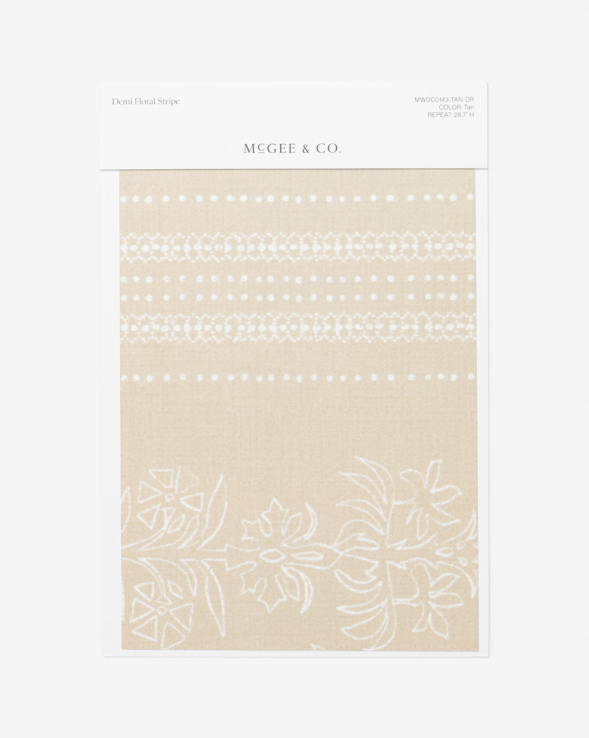 A Demi Floral Stripe Wallpaper Swatch by Vendixs shows a tan background with white floral and dotted stripes, reminiscent of elegant wallpaper. The fabric sample is attached to a white card featuring product details at the top, and is branded with Vendixs