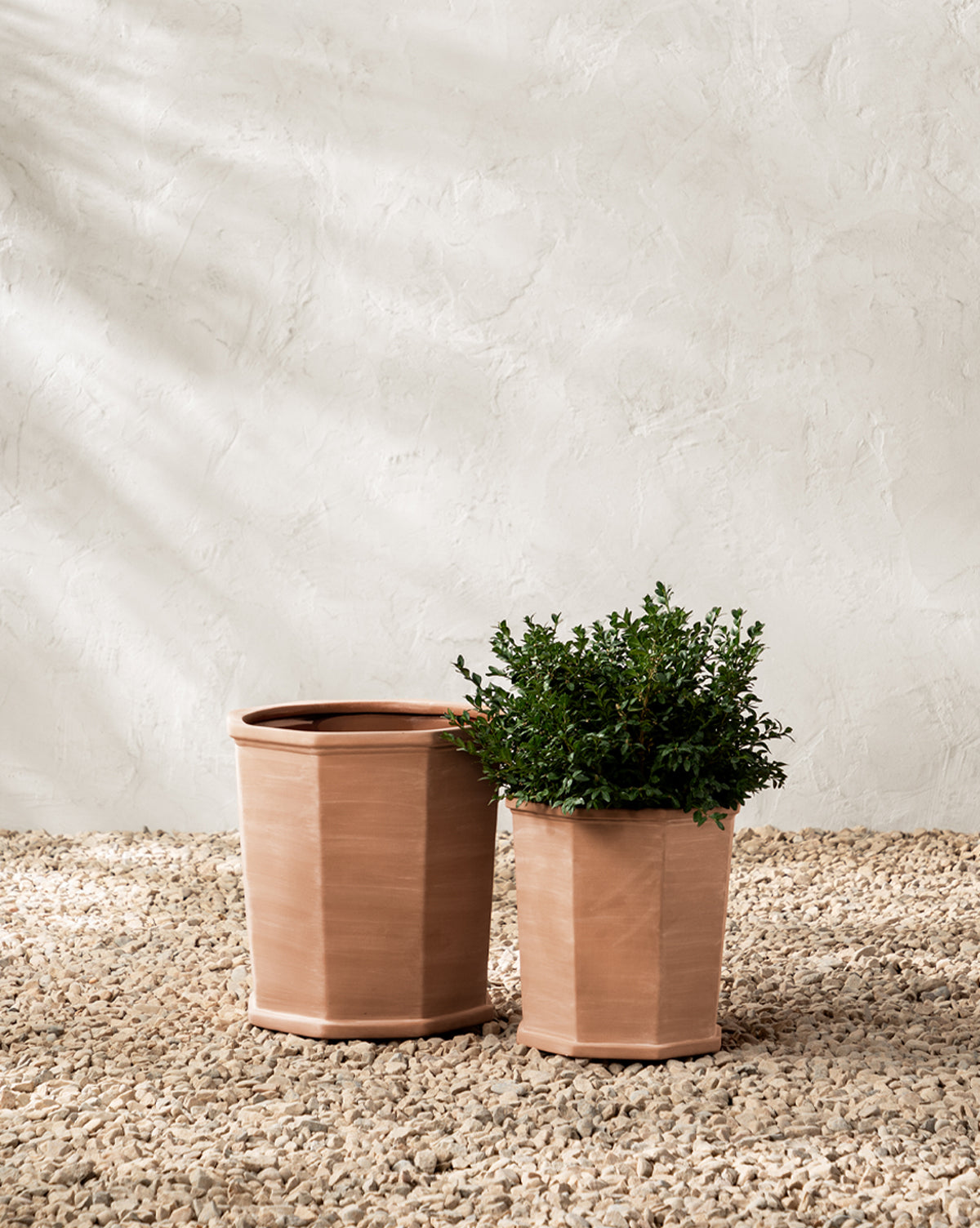 Dempsey Planters in terracotta, styled as a pair in different sizes for outdoor decor, from Vendixs