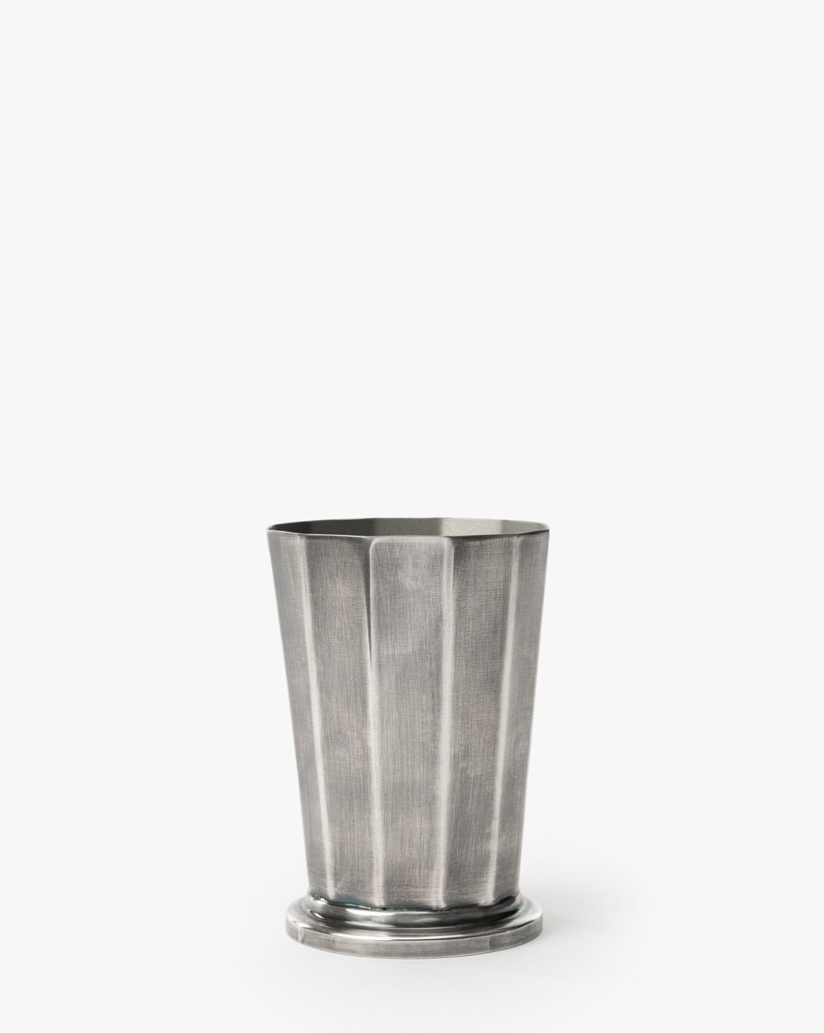 The Derby Vase, featuring a silver finish with fluted vertical ridges and a round base, is ideal for elegant flower arrangements and stands out against a plain white background, by Vendixs