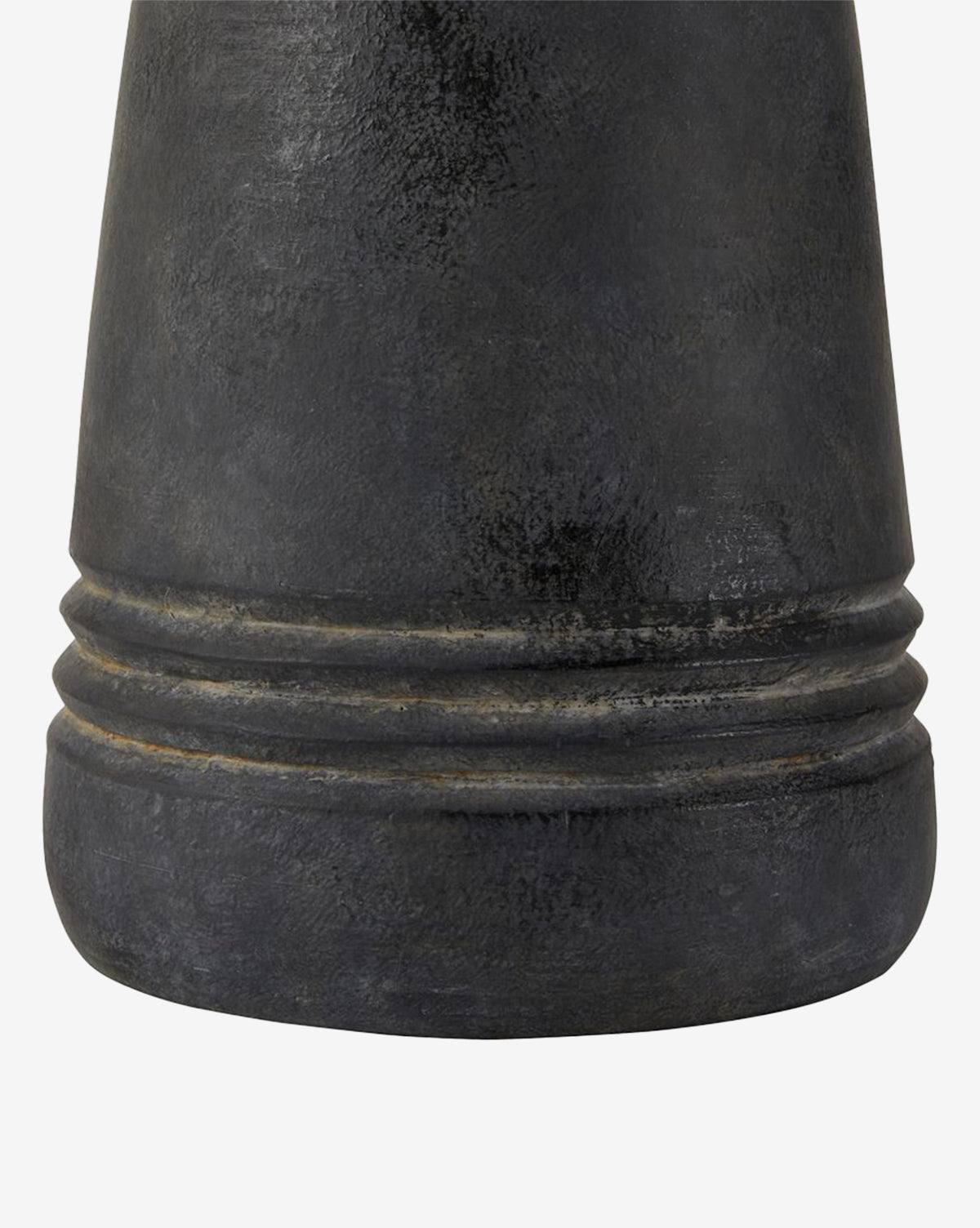 Close-up of the Django Table Lamps textured dark gray base with two horizontal grooves near the bottom, featuring a matte, slightly worn finish that pairs elegantly with its linen shade, by Vendixs