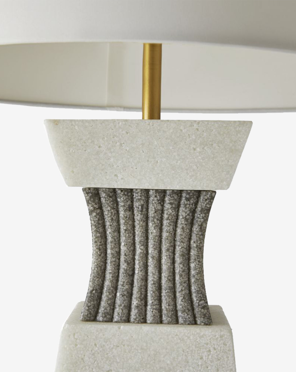The Dynasty Table Lamp showcases a white stone base, a gray ribbed center, and a gold metal stem, all topped with a tapered off-white shade, by Vendixs