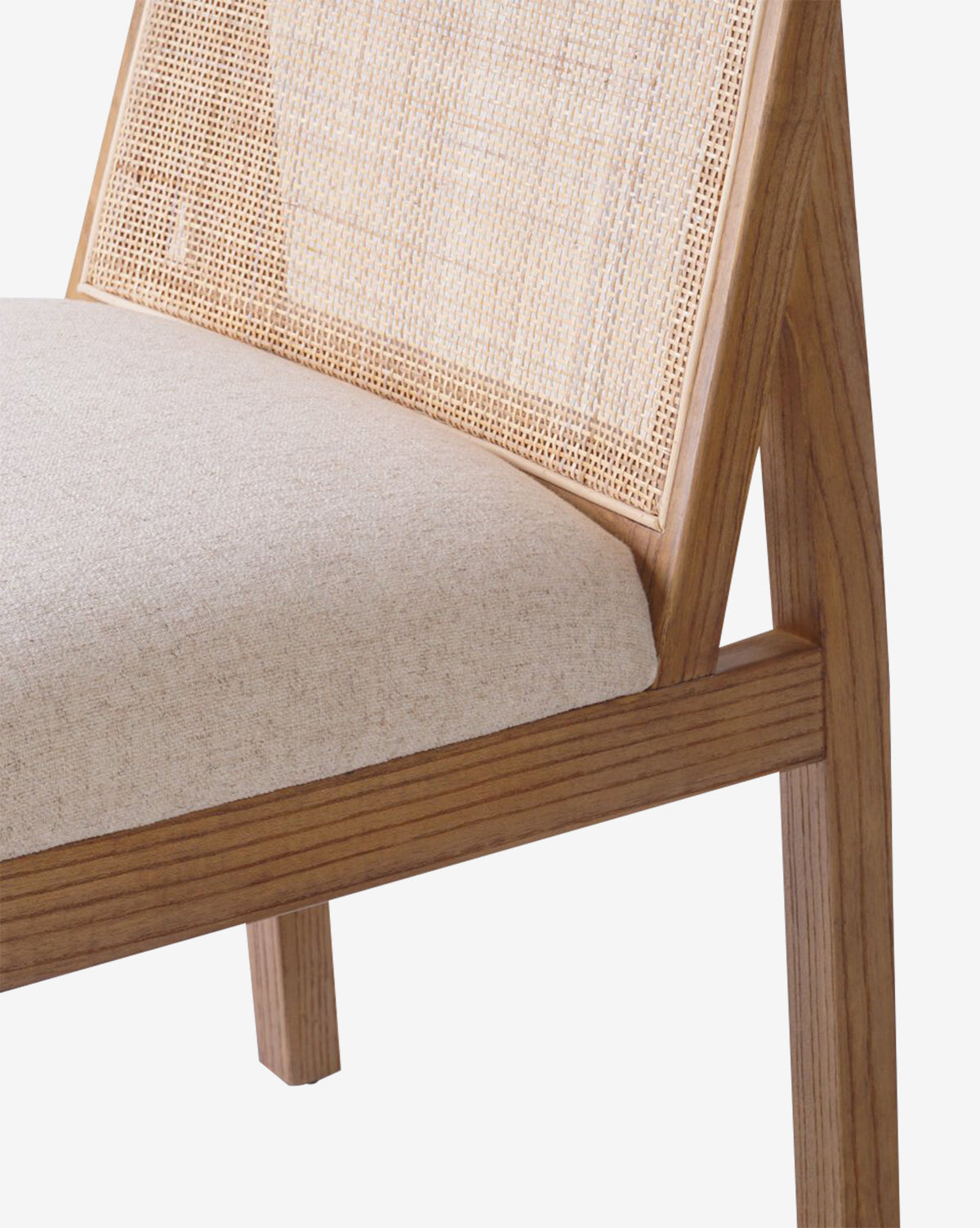 Close-up of the Eira Dining Chair, showcasing a performance fabric seat, woven cane back, and a sleek, minimalist design by McGee & Co.
