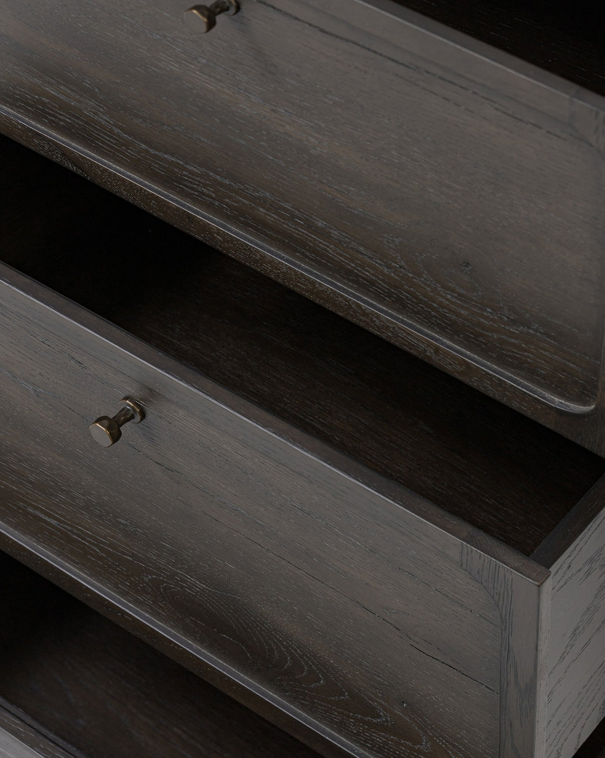 Two dark wood drawers of the Eldoria Oak Sideboard, featuring metallic knobs and visible grain on the fronts and sides, are partly open to show their empty interiors, showcasing its modern deco style, by Vendixs