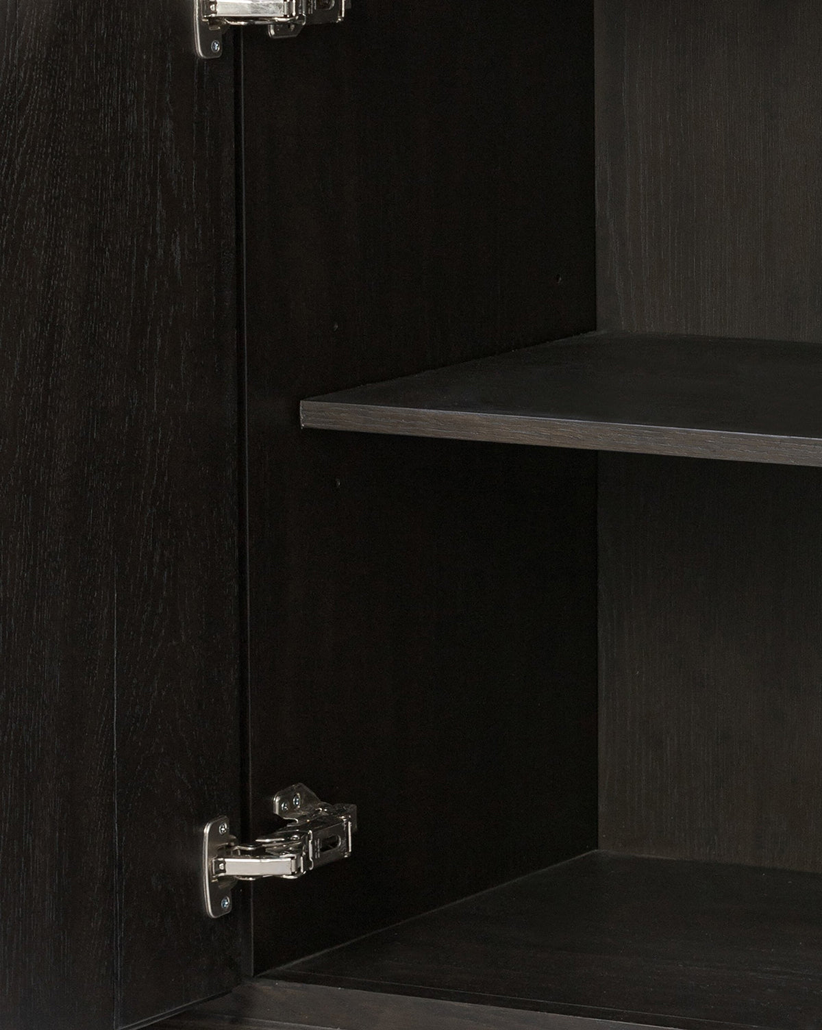 Close-up of the Eldoria Oak Sideboards interior in black oak, featuring two metal hinges on the left and two empty shelves—a sleek modern deco furniture piece, by Vendixs