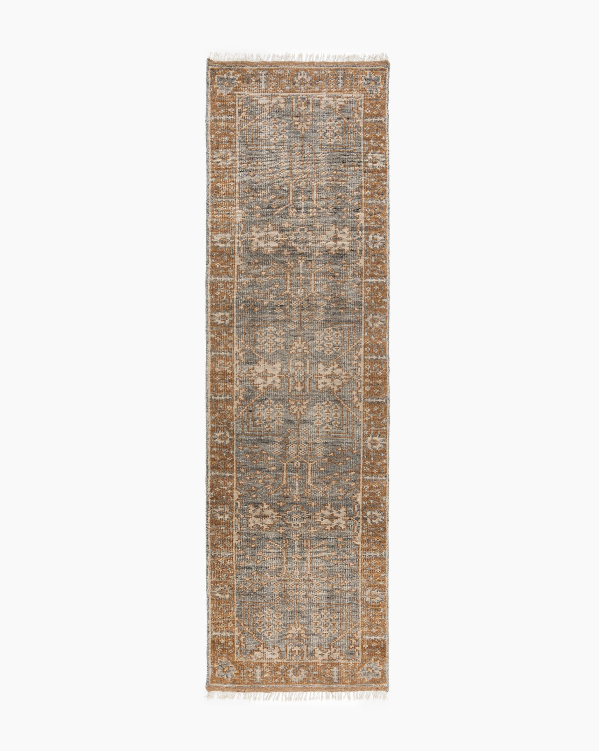The Elison Hand-Knotted Wool Rug features a distressed vintage pattern in muted blue, beige, and brown with a detailed border and fringed edges on the short sides, inspired by traditional textiles, by Vendixs