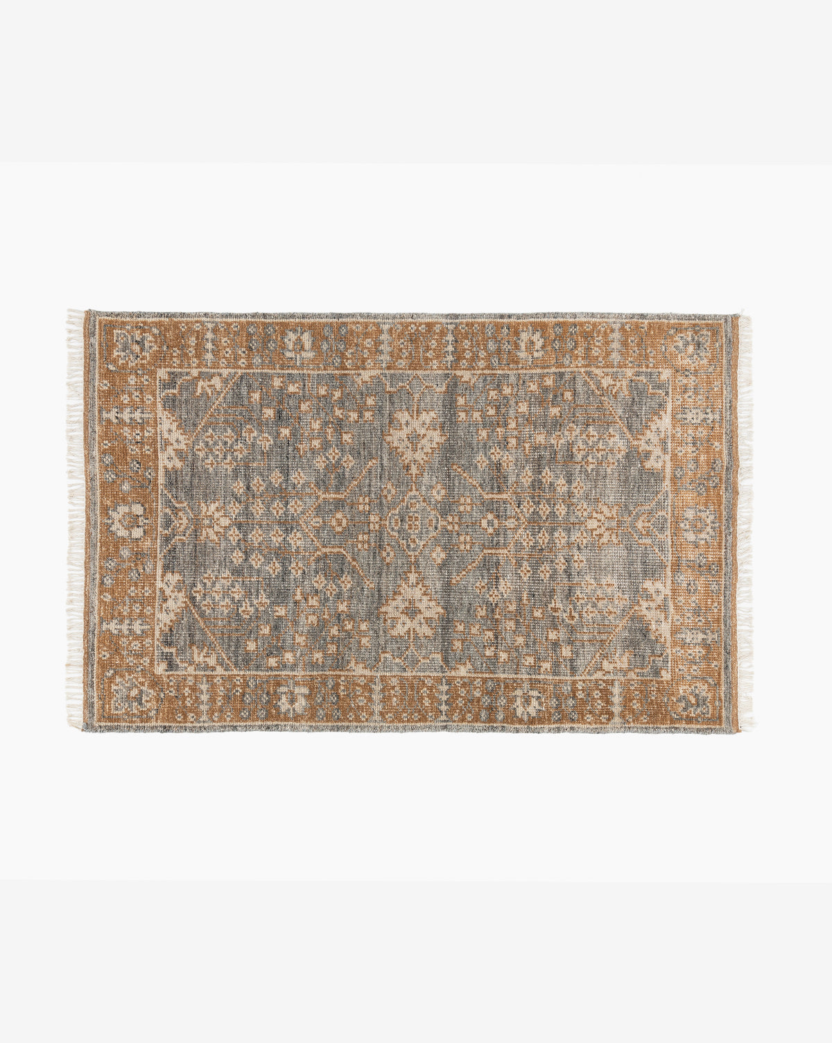 The Elison Hand-Knotted Wool Rug showcases intricate floral and geometric patterns in muted blue and tan, artisan-crafted borders, and short fringe on the shorter sides, by Vendixs