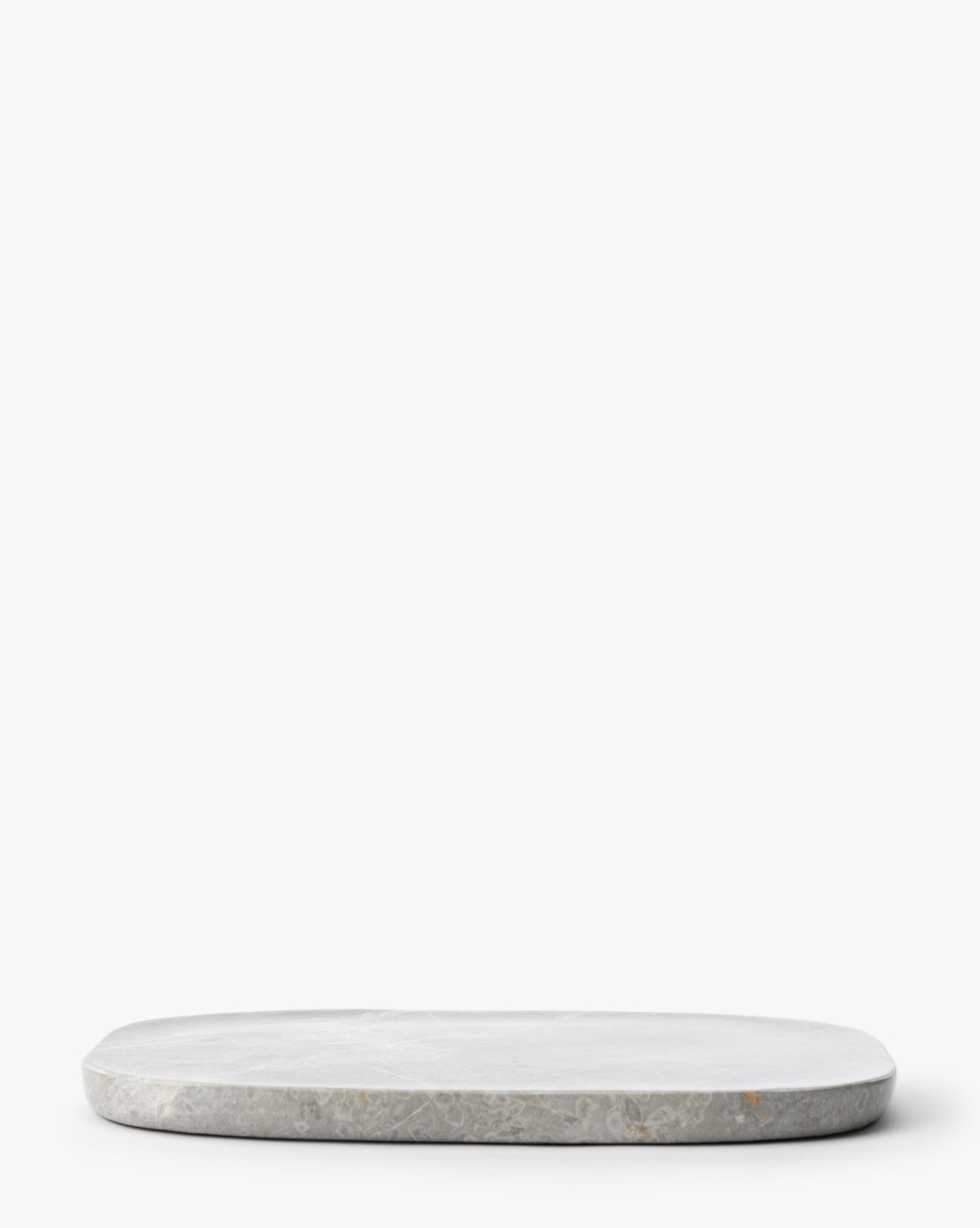 The Eliza Marble Tray, a round and flat gray marble tray, is placed on a white background with empty space above, by Vendixs