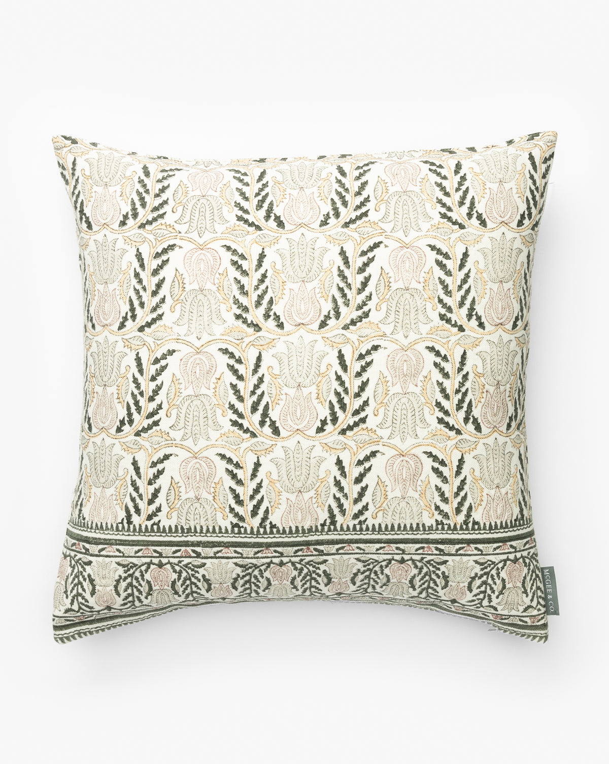 The Ellsbeth Pillow Cover features a beige background with an intricate floral and leaf block print in muted green and soft pink, plus a decorative border on one edge and a small fabric tag, by Vendixs