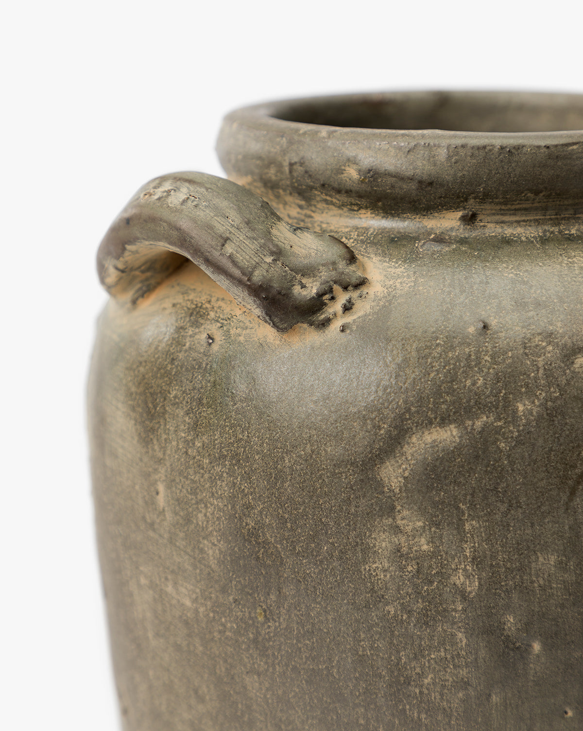 A close-up of the Emilio Urn, a rustic ceramic pot with a small curved handle near the rim. Its earthy texture and greenish-brown hue make it an ideal vintage home decor accent or shelf accessory against a white background, by Vendixs